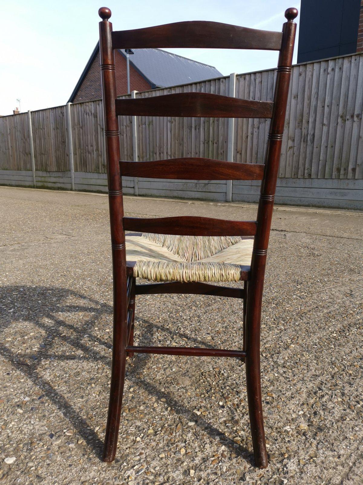 Late 19th Century Liberty & Co. An English Aesthetic Movement Walnut Ladder Back Rush Seat Chair For Sale