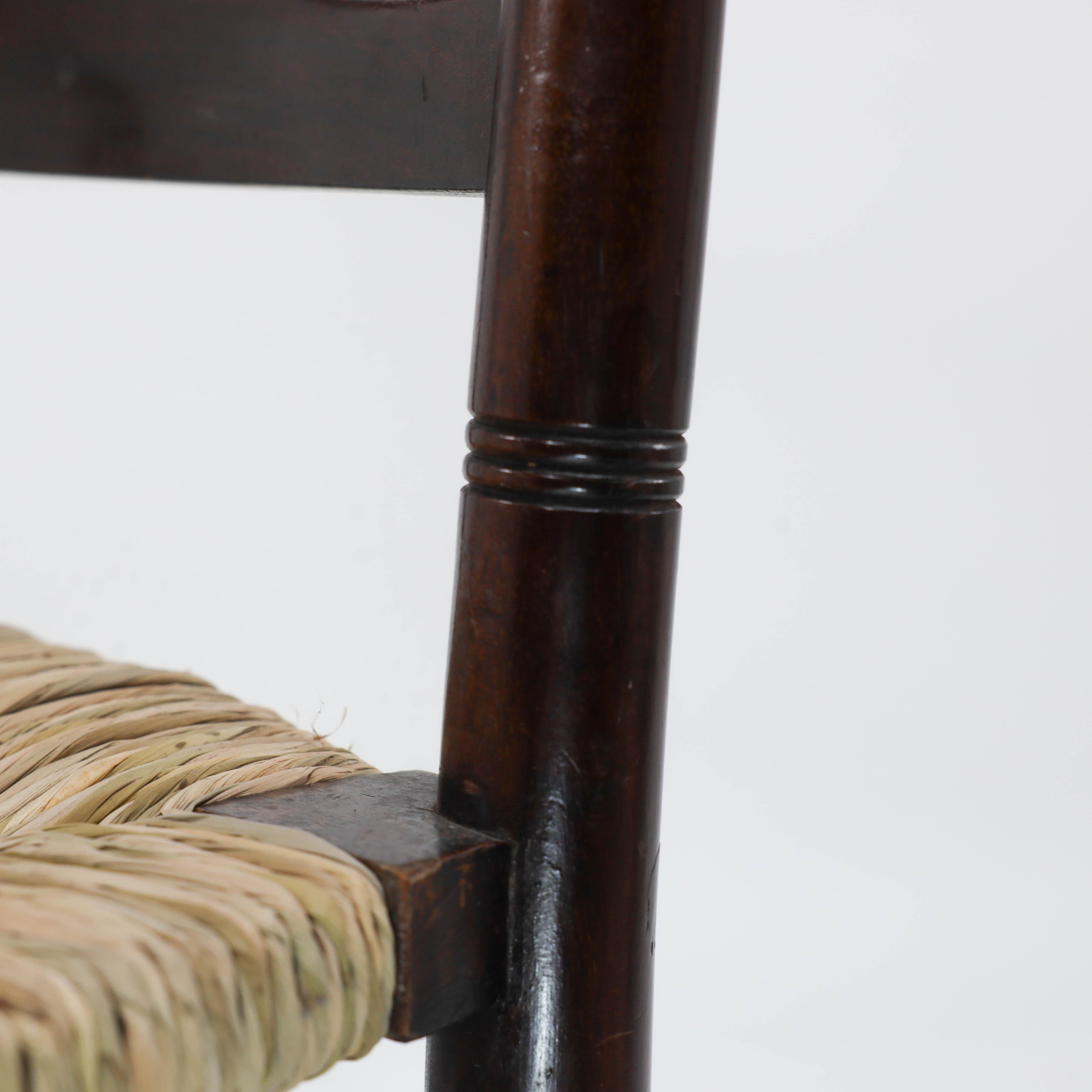 Liberty & Co. An English Aesthetic Movement walnut ladder back rush seat chair In Good Condition For Sale In London, GB