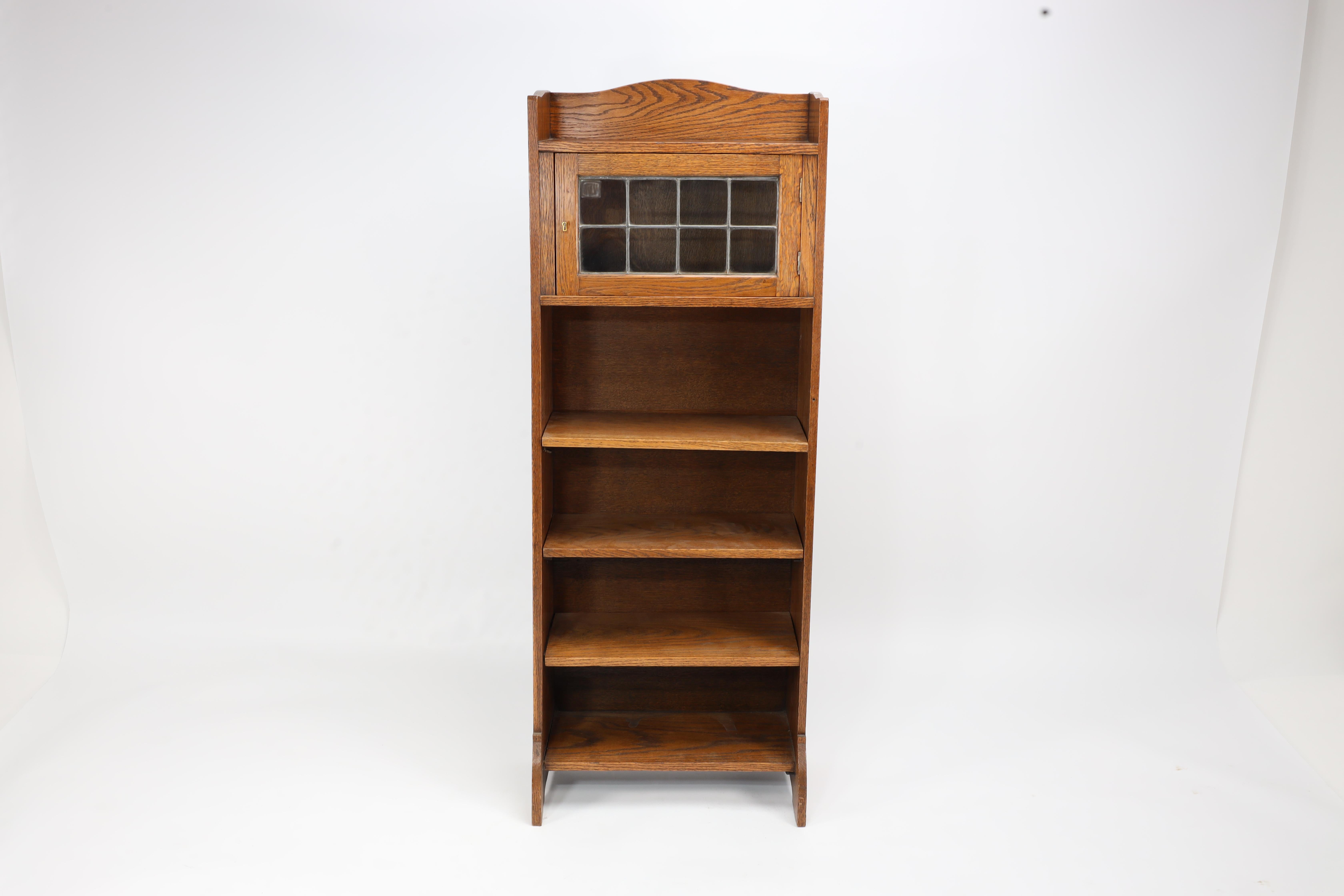 Arts and Crafts Liberty & Co. an English Arts & Crafts Oak Bookcase, with Shaped Upper Details For Sale