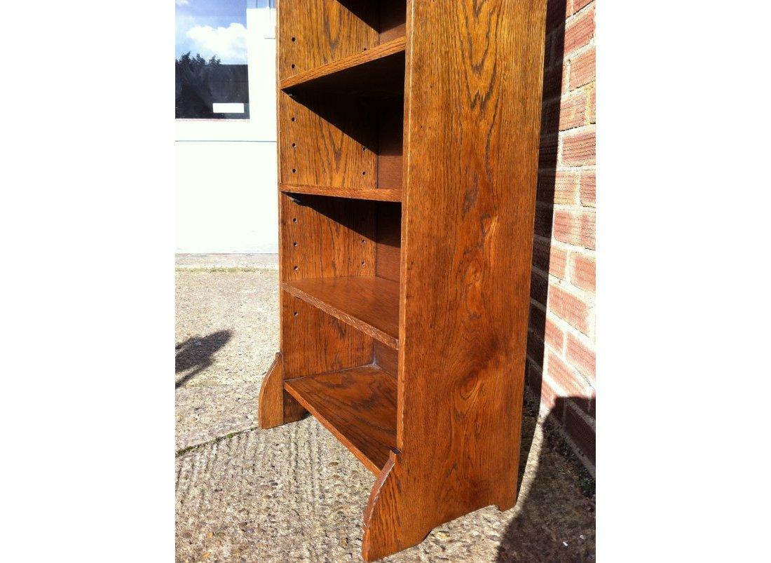 Early 20th Century Liberty & Co. an English Arts & Crafts Oak Bookcase, with Shaped Upper Details For Sale
