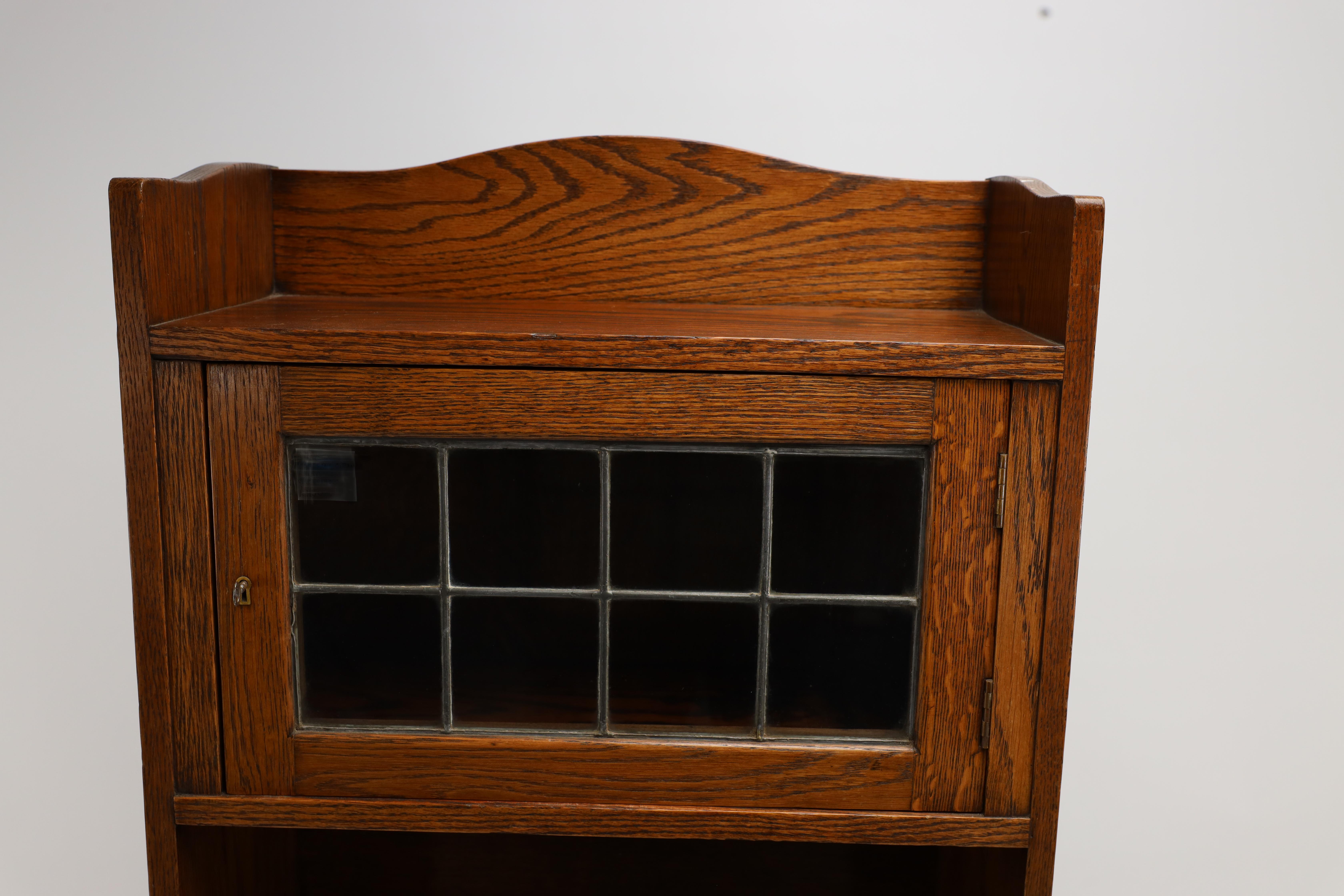Liberty & Co. an English Arts & Crafts Oak Bookcase, with Shaped Upper Details For Sale 1