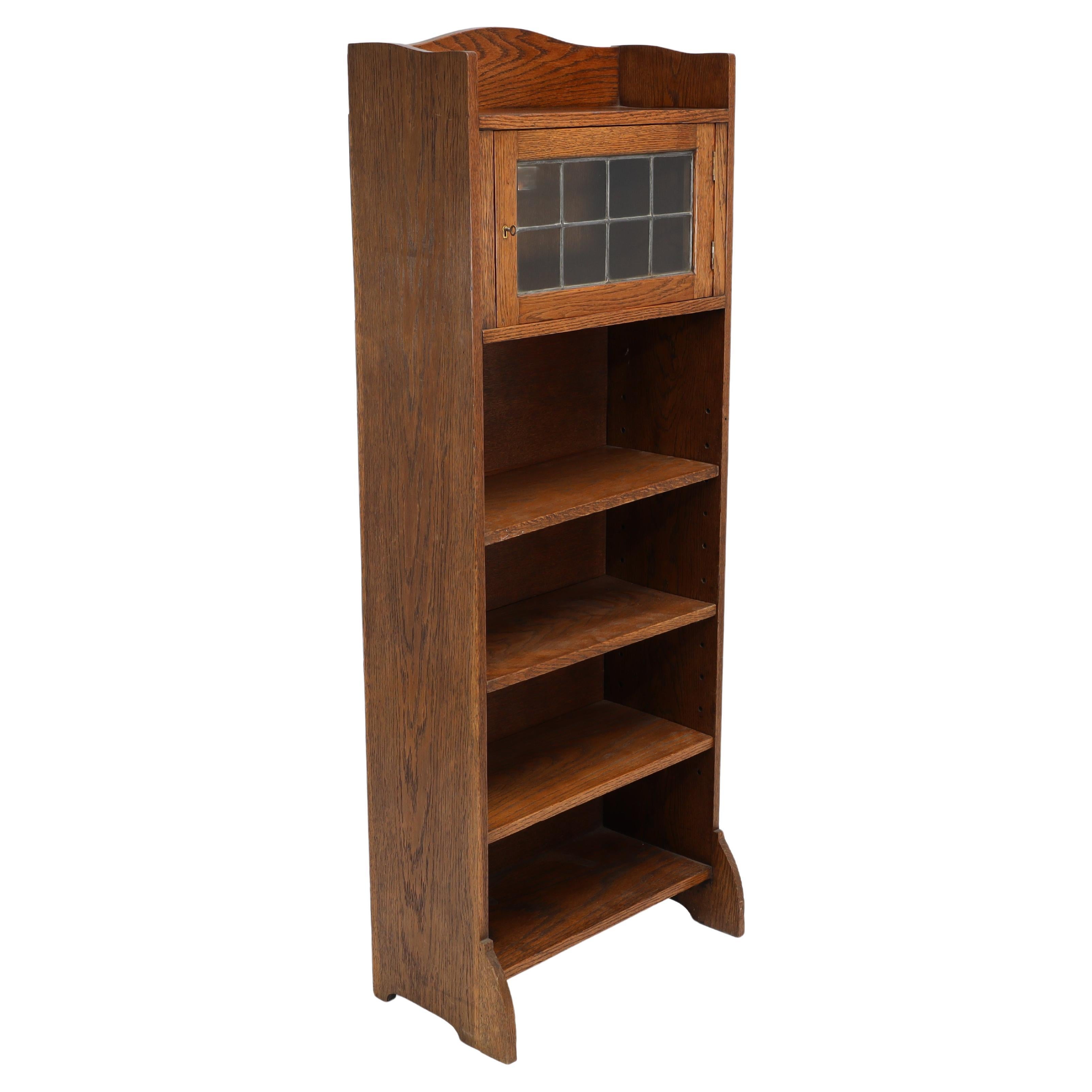 Liberty & Co. an English Arts & Crafts Oak Bookcase, with Shaped Upper Details For Sale