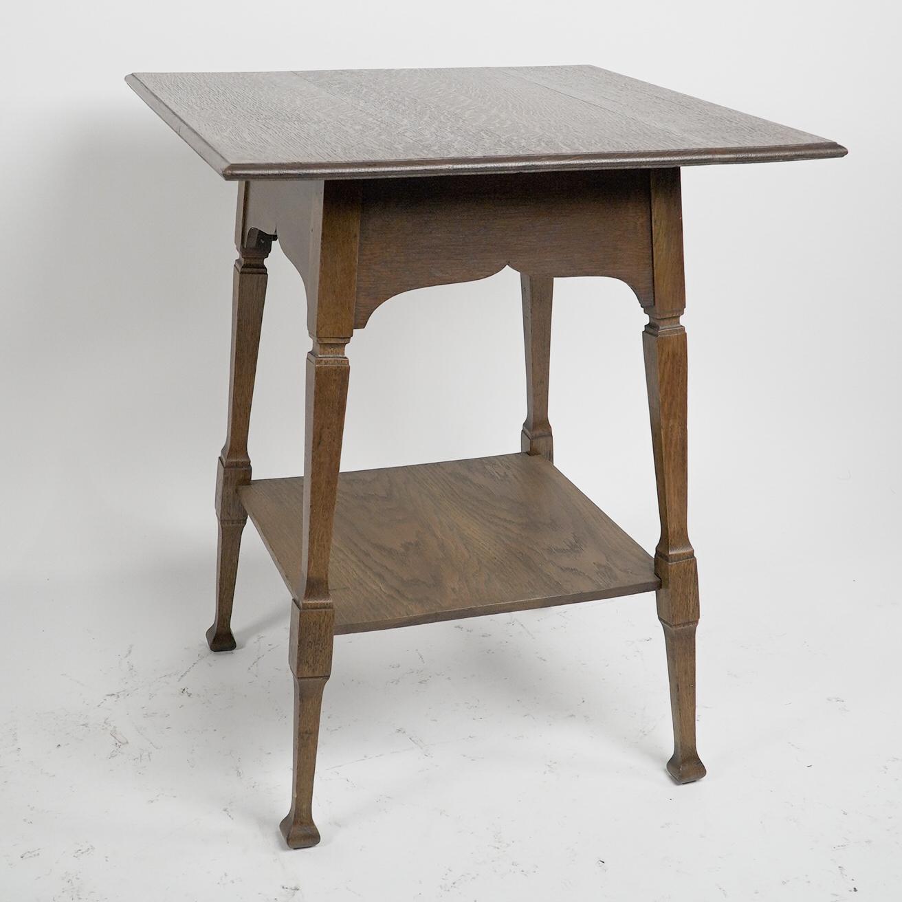 Arts and Crafts Liberty & Co. An Arts & Crafts oak two tier side table with Moorish aprons. For Sale