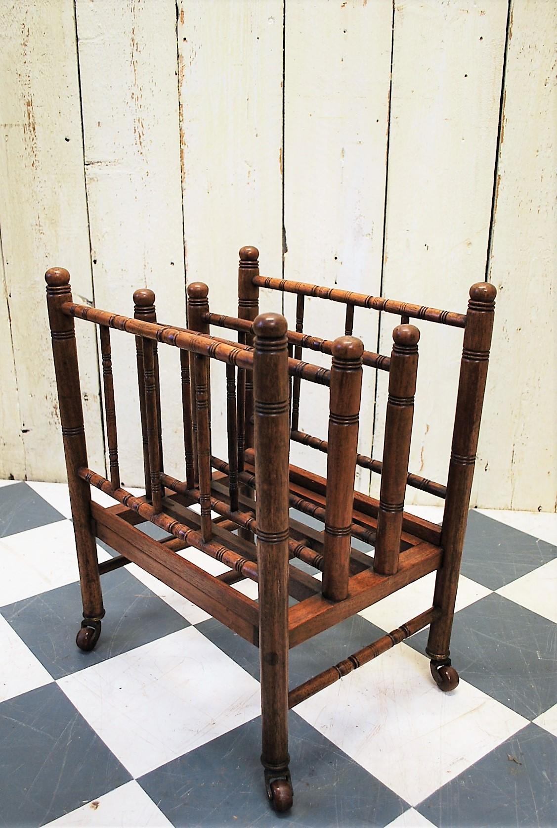 A rare and unusual Liberty & Co. magazine rack or canterbury, circa 1910. Beautifully made and very sturdy in solid walnut, with fine quality turnings. Standing on original porcelain castors with brass ferrels. A rare and unusual piece of liberty's