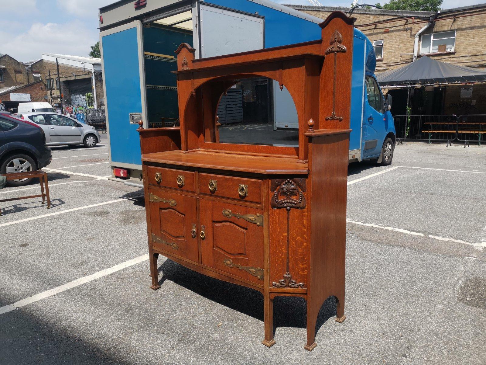 Arts and Crafts Liberty & Co Attr. An English Arts & Crafts Oak Sideboard with Carved Decoration For Sale