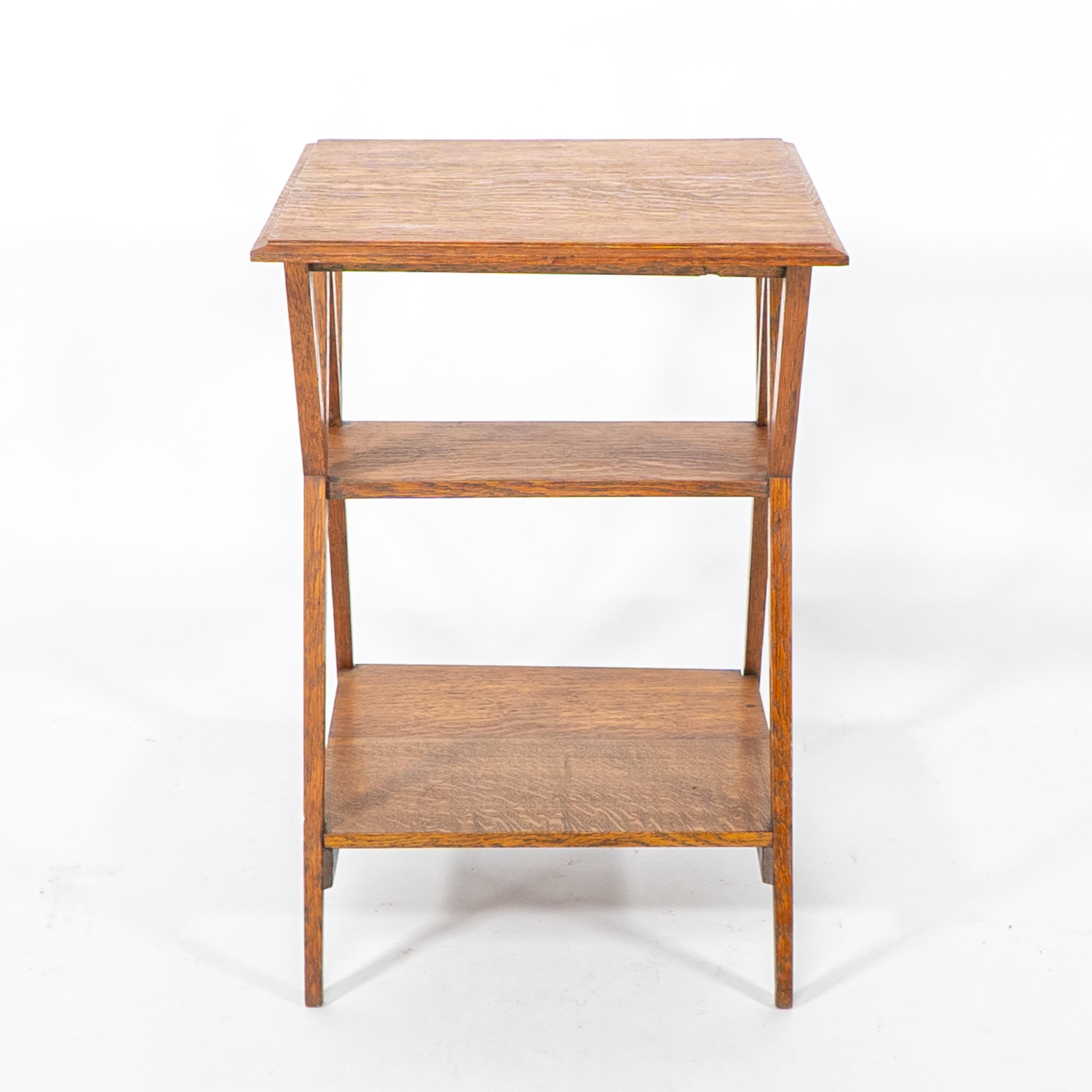 Liberty and Co attr. Table d'appoint en chêne de bonne qualité et bien conçue, de style Arts and Crafts, à trois niveaux, avec supports angulaires.