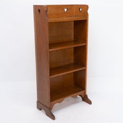 Liberty & Co. attri. An Arts & Crafts oak bookcase with stylized heart cut-outs
