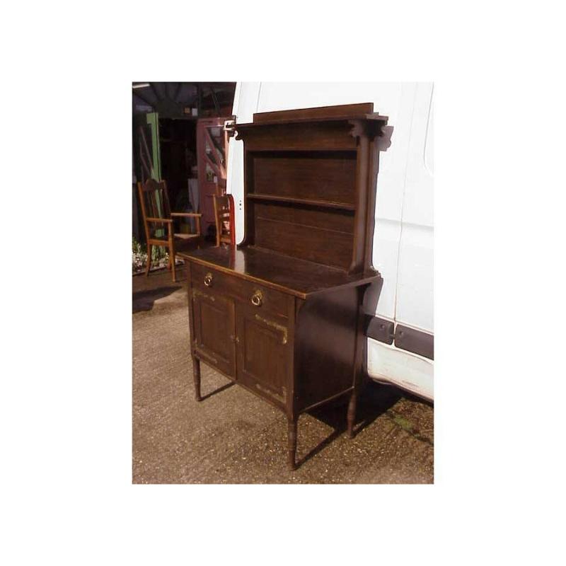A good quality oak Moorish dresser attributed to Liberty and Co with plate rack to the upper section and two drawers with two cupboards below, superb quality stylised handles and hinges, the legs are a feature that Liberty have used on their Thebes