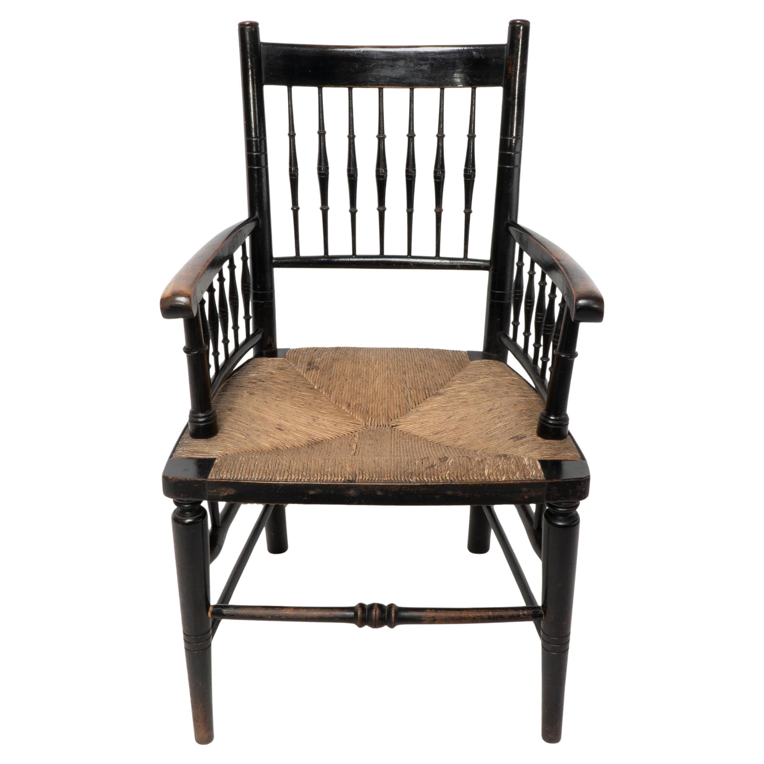 Liberty & Co, attributed. An Aesthetic Movement rush seat armchair