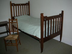 Liberty & Co. Attributed, an Arts & Crafts Oak Bed with Stylized Floral Cut-Outs