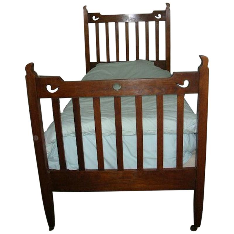 Liberty & Co. Attributed, an Arts & Crafts Oak Bed with Stylized Floral Cut-Outs