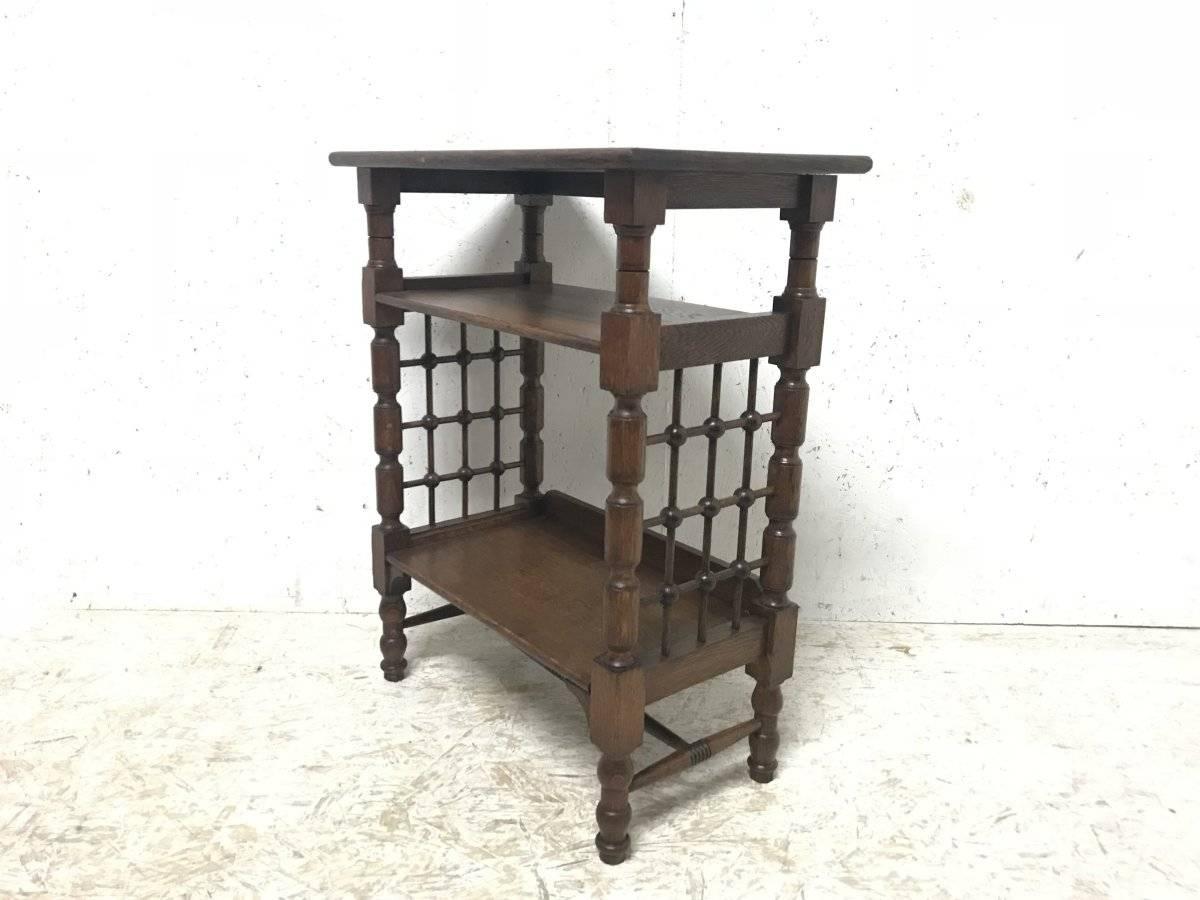 Liberty & Co. attributed. Made by William Birch.
An Arts & Crafts three-tier book stand with Moorish turned lattice work decoration to the sides with turned legs united by a turned and incised H stretcher.