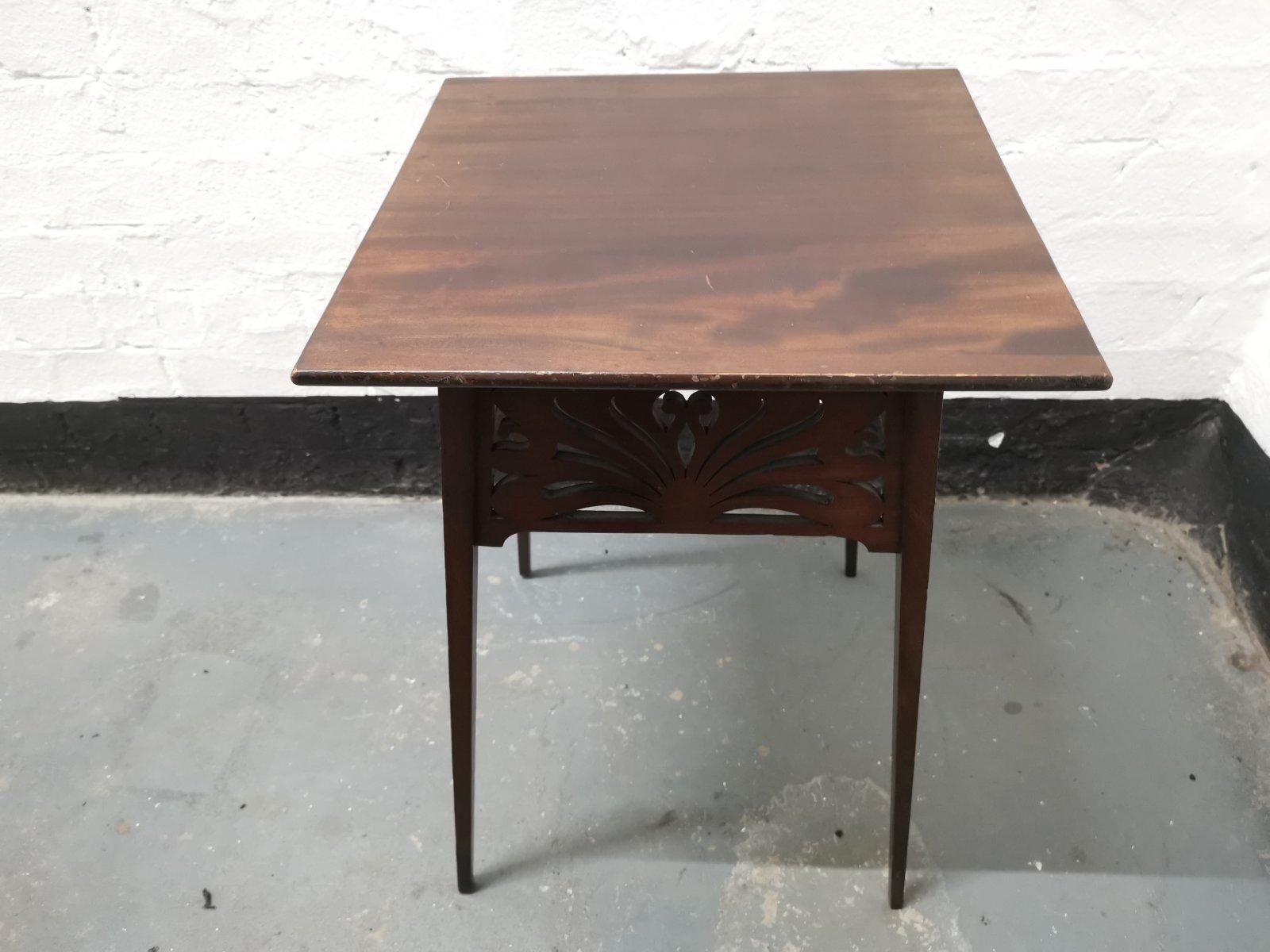 Liberty & Co, in the style of A H Mackmurdo.
An Art Nouveau Mahogany side table with four organic fretwork panels on fine tapering legs.
The last two images show a variation of this table from the Liberty 1895 Yuletide catalog with different