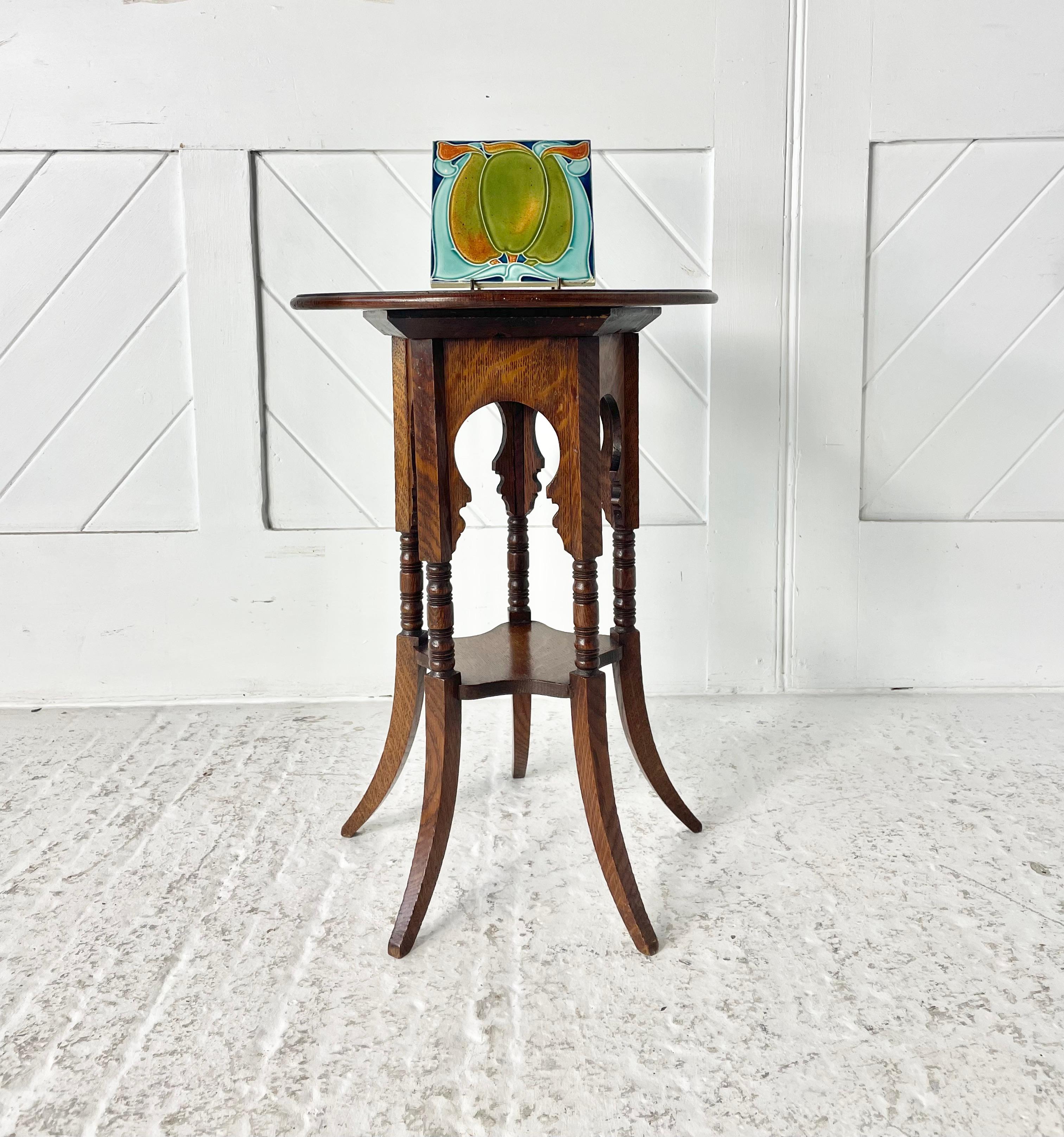 A beautiful small oak side table in the style of E.W. Godwin, with five out swept legs and Moresque style frieze with circular quarter sawn oak top. Liberty & Co early paper label to underside.

Circa 1895

Height 54cm

Dia 38cm