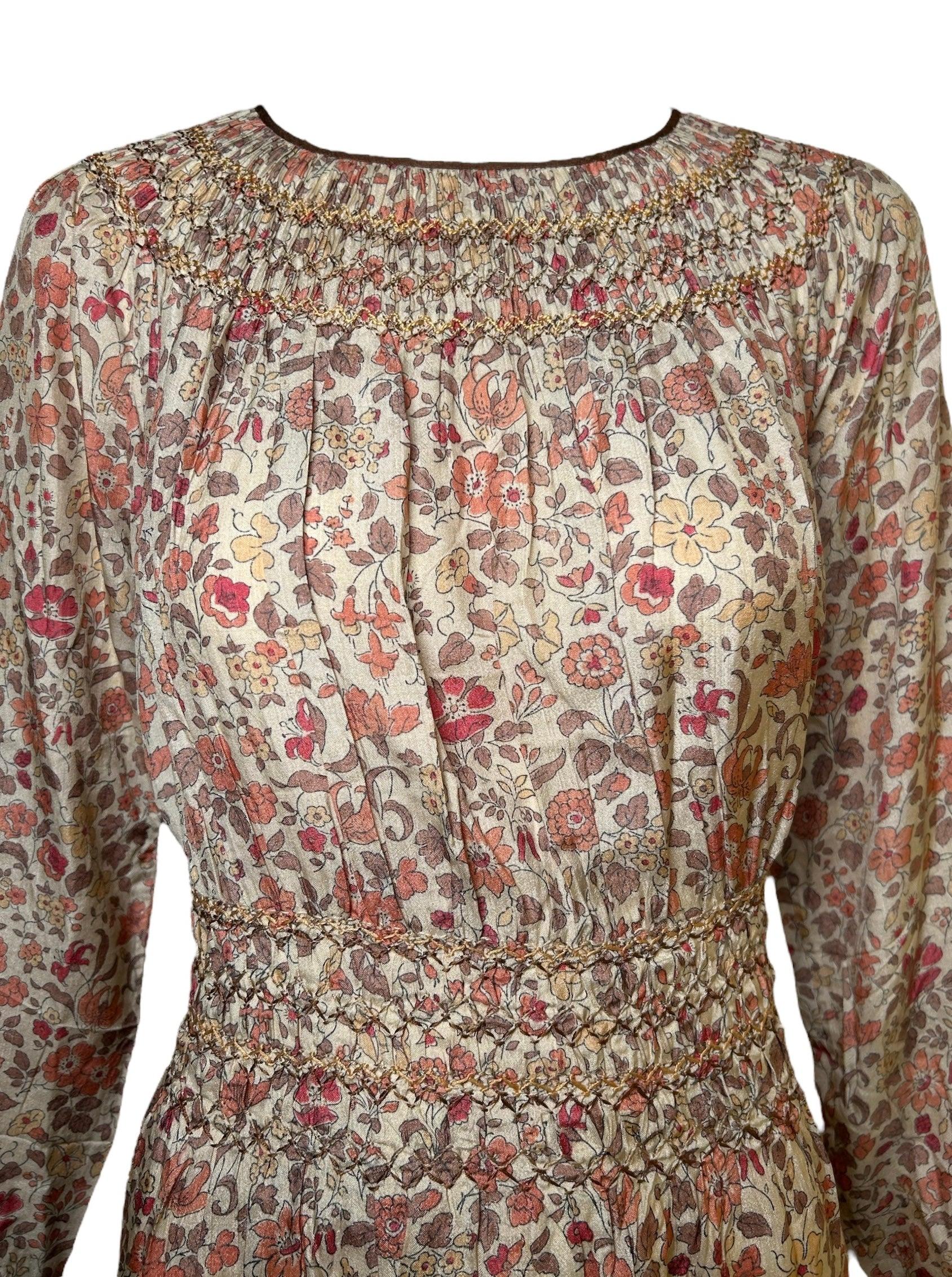A perfect example of '30s comfort and casual beauty. The warm florals on this dress are gorgeous and soft. The zig zag smocking stitch that lines the collar sleeves and waist are multi-colored in the same earth tones are are a lovely addition to