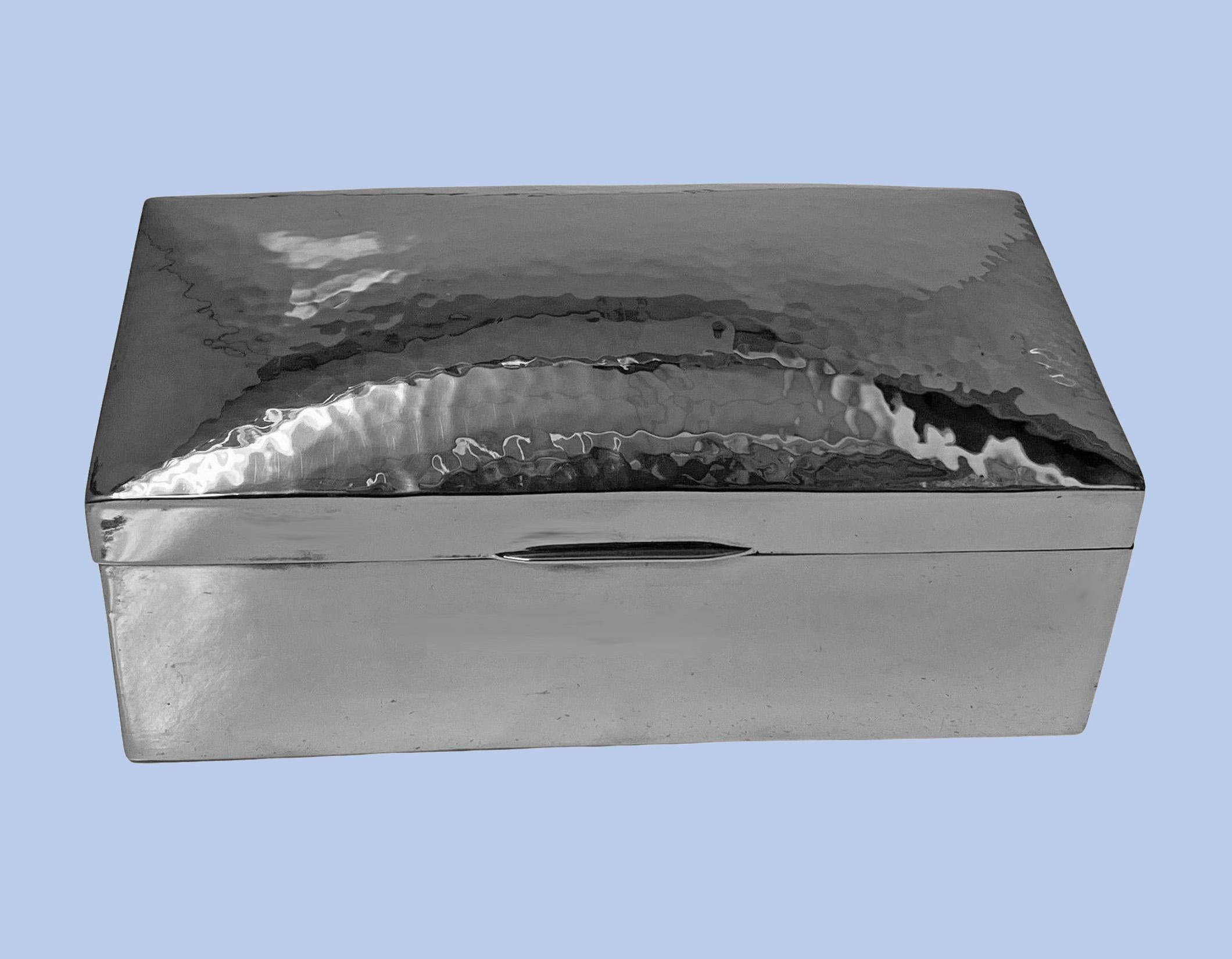 Liberty & Co hammered polished pewter box, C.1920, marked on underside Tudric 01021 Made in England. The box of rectangular shape with hinged dome shape cover. The entire box of hammered design, cedar lined interior. Box measures approximately 6.75
