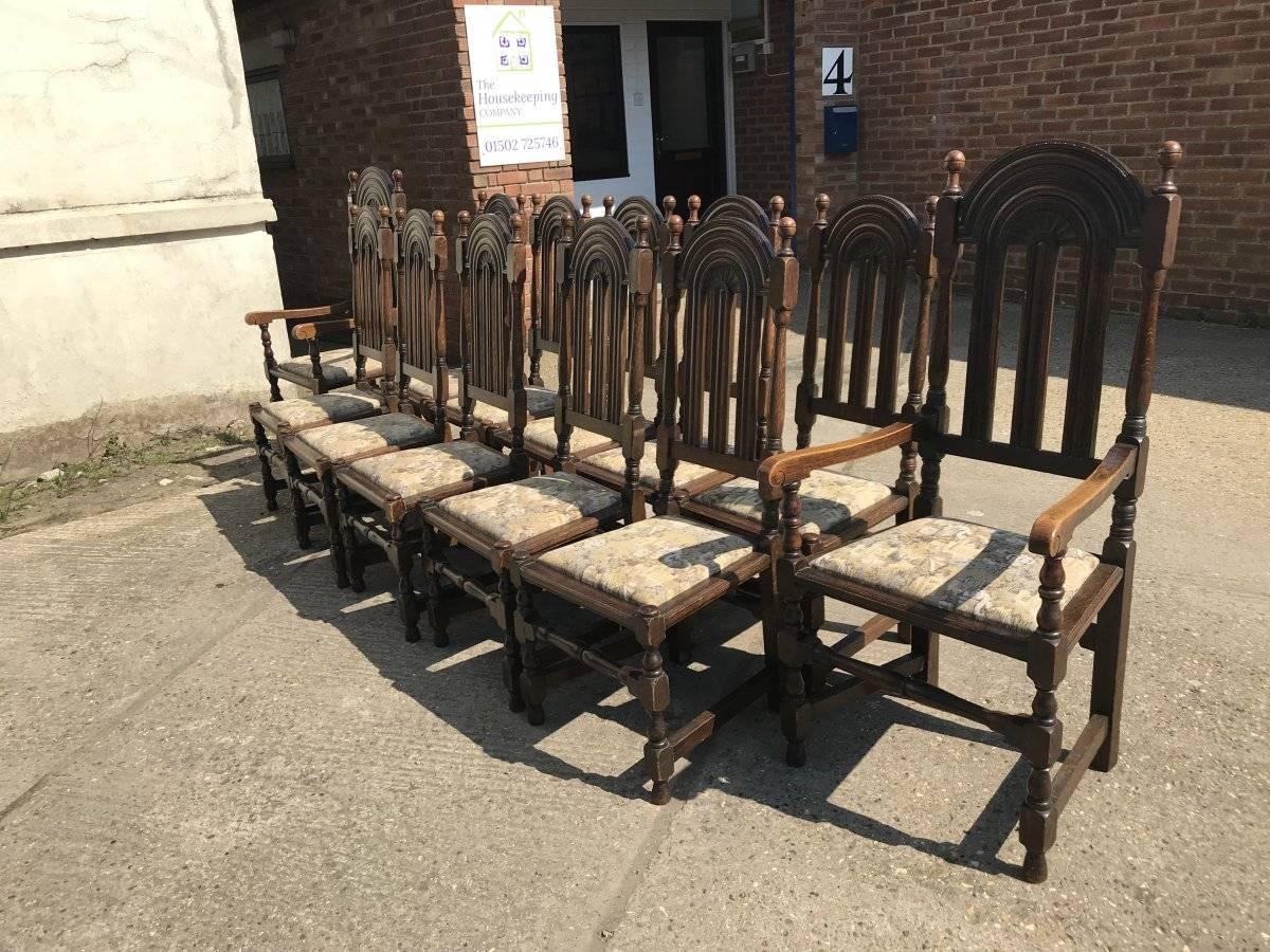 Liberty & Co. A rare set of 14 Arts & Crafts oak dining chairs with a subtle Gothic Revival style about them, consisting of twelve side chairs and two armchairs, all with drop in seats.
Sets of fourteen were in Victorian times classed as a true