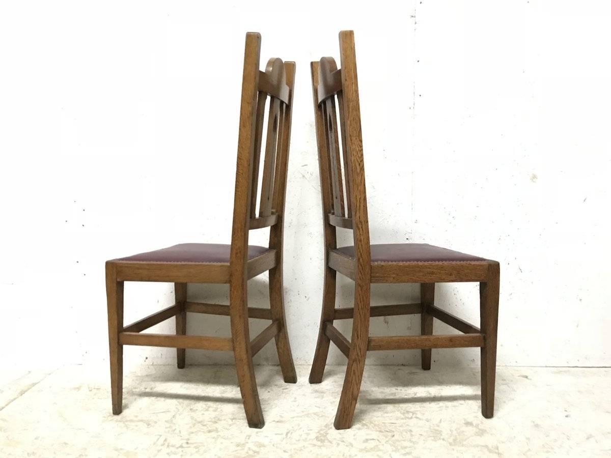 English Liberty & Co, Ten Arts & Crafts Oak Dining Chairs with Stylised Floral Details
