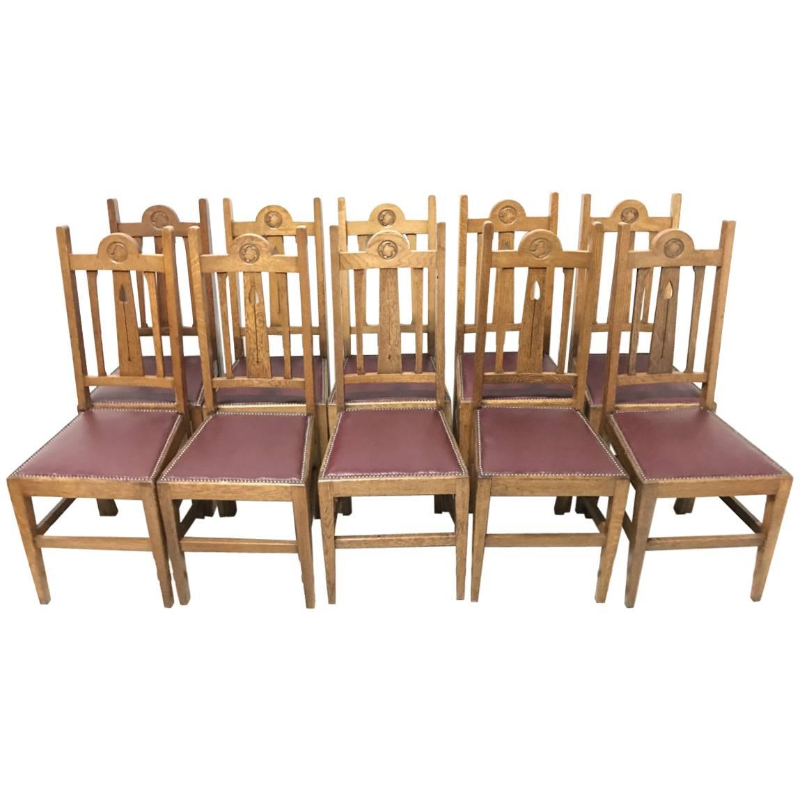 Liberty & Co, Ten Arts & Crafts Oak Dining Chairs with Stylised Floral Details
