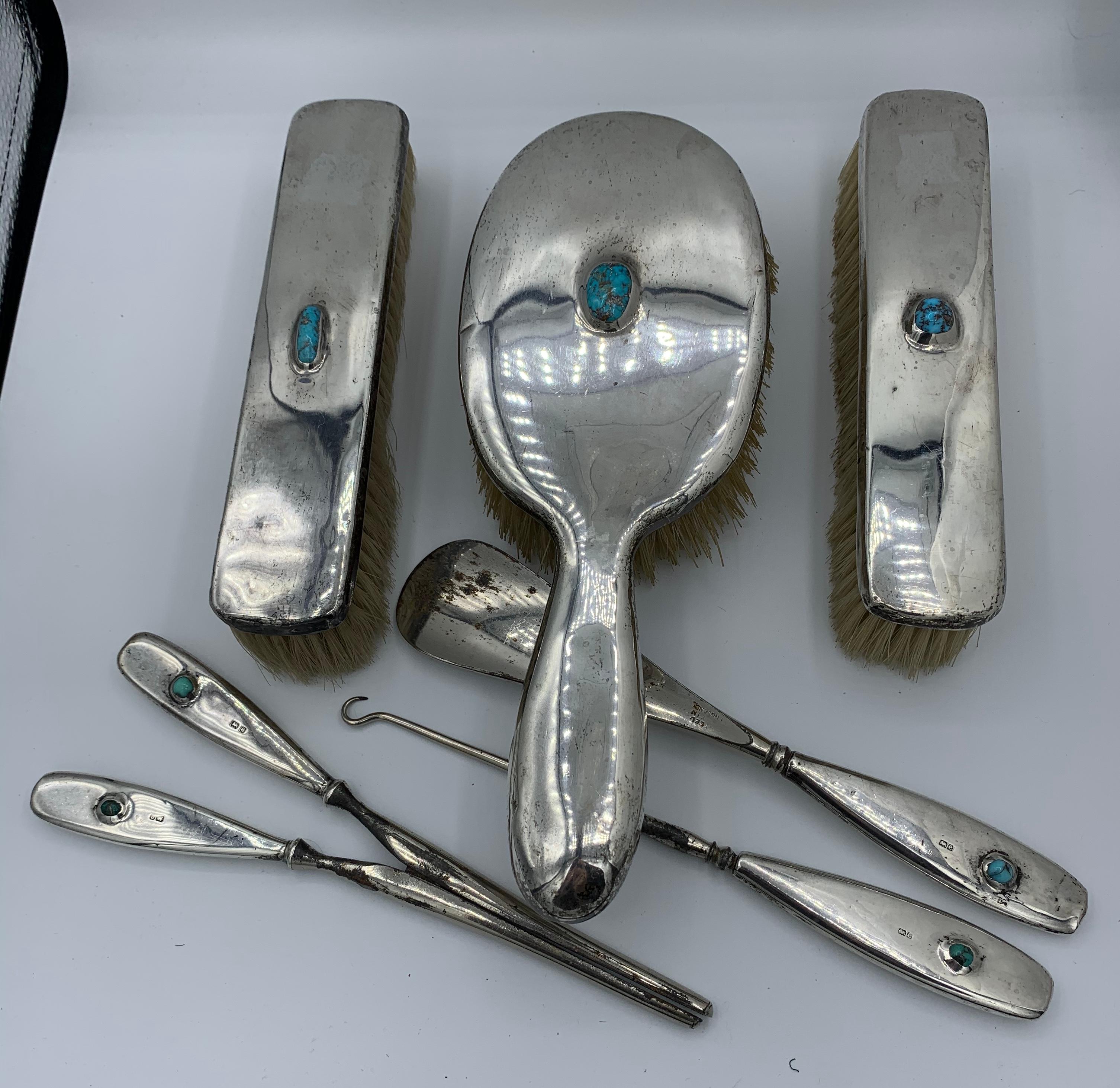 This is a gorgeous and very rare Museum Quality Liberty & Co. Sterling Silver and Turquoise Cymric Pattern Six-Piece Dresser Set from the estate of legendary philanthropist and collector Jacqueline Loewe Fowler, whose jewels are in the collection of