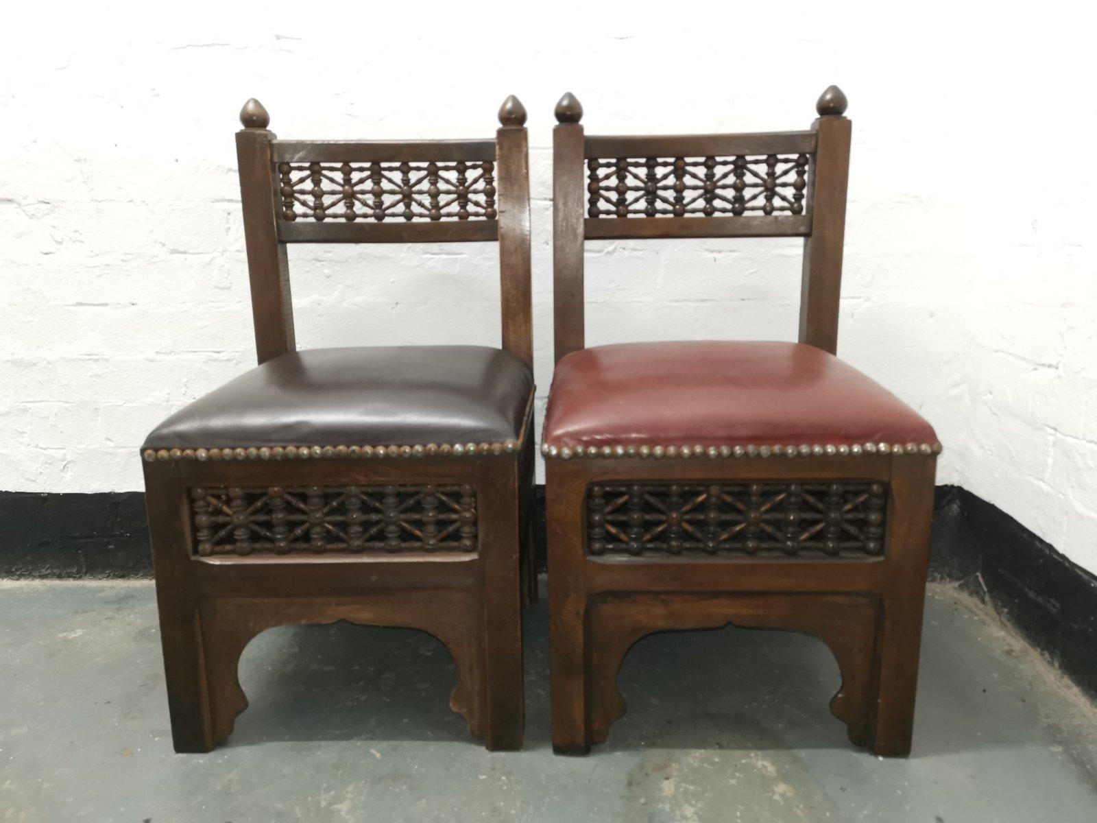 Liberty & Co.
Two good quality Moorish side or child's chair with Mashrabiya turned details to the backrest and on all four sides below the seats, one with a black studded leather seat, and one with a red studded leather seat, both with Moorish