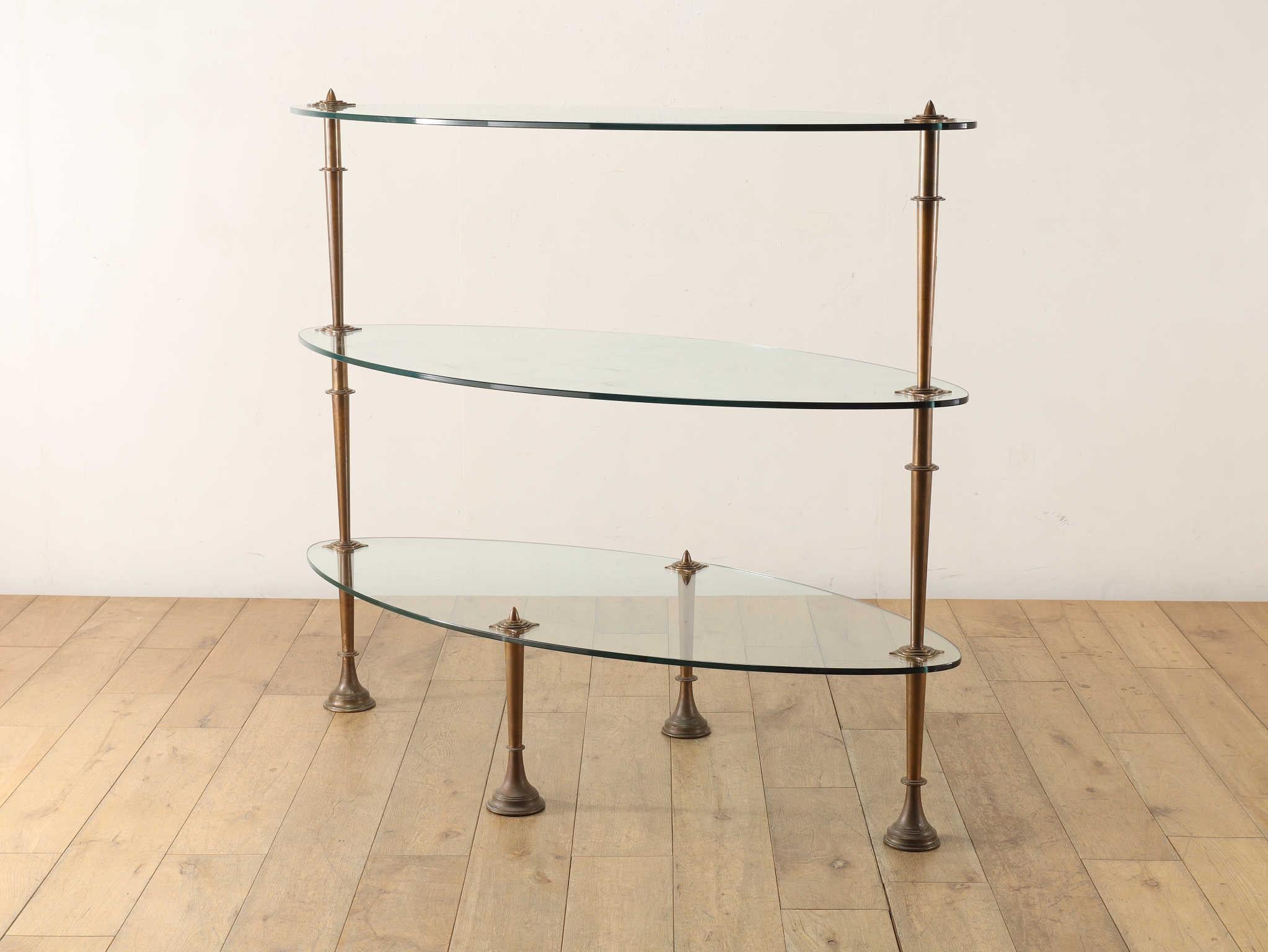 This elegant display piece was originally used as a store fixture at Liberty, the iconic and historic department store in London, renowned for its contributions to art, design, and craftsmanship.
With its refined bronze supports and sleek glass