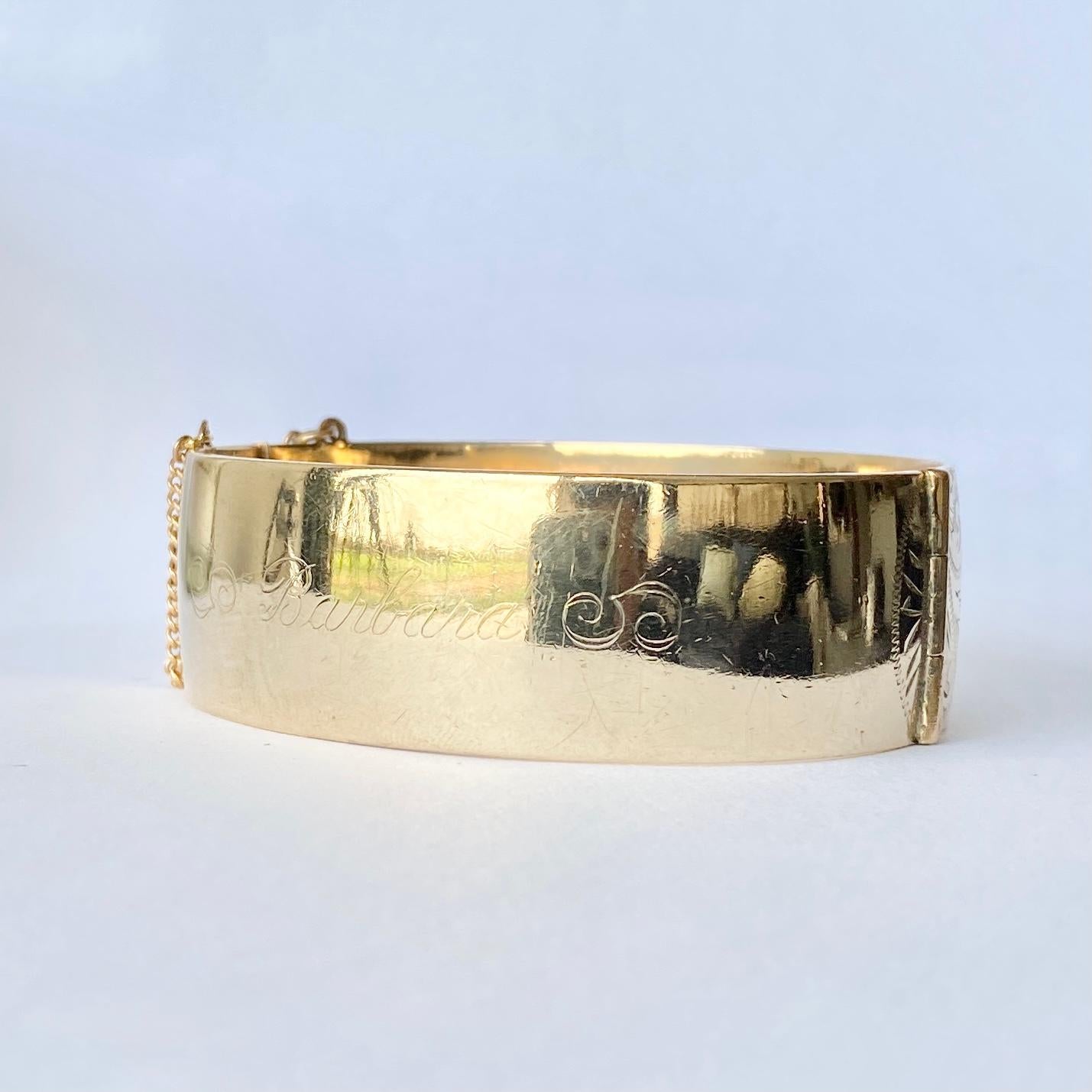 This  Liberty of London bangle is a classic design with fine swirl and leaf engraving on one half of the bangle. The bangle is modelled in 9ct gold with metal core and is hallmarked L&co. The back of the bangle has faint engraving which reads