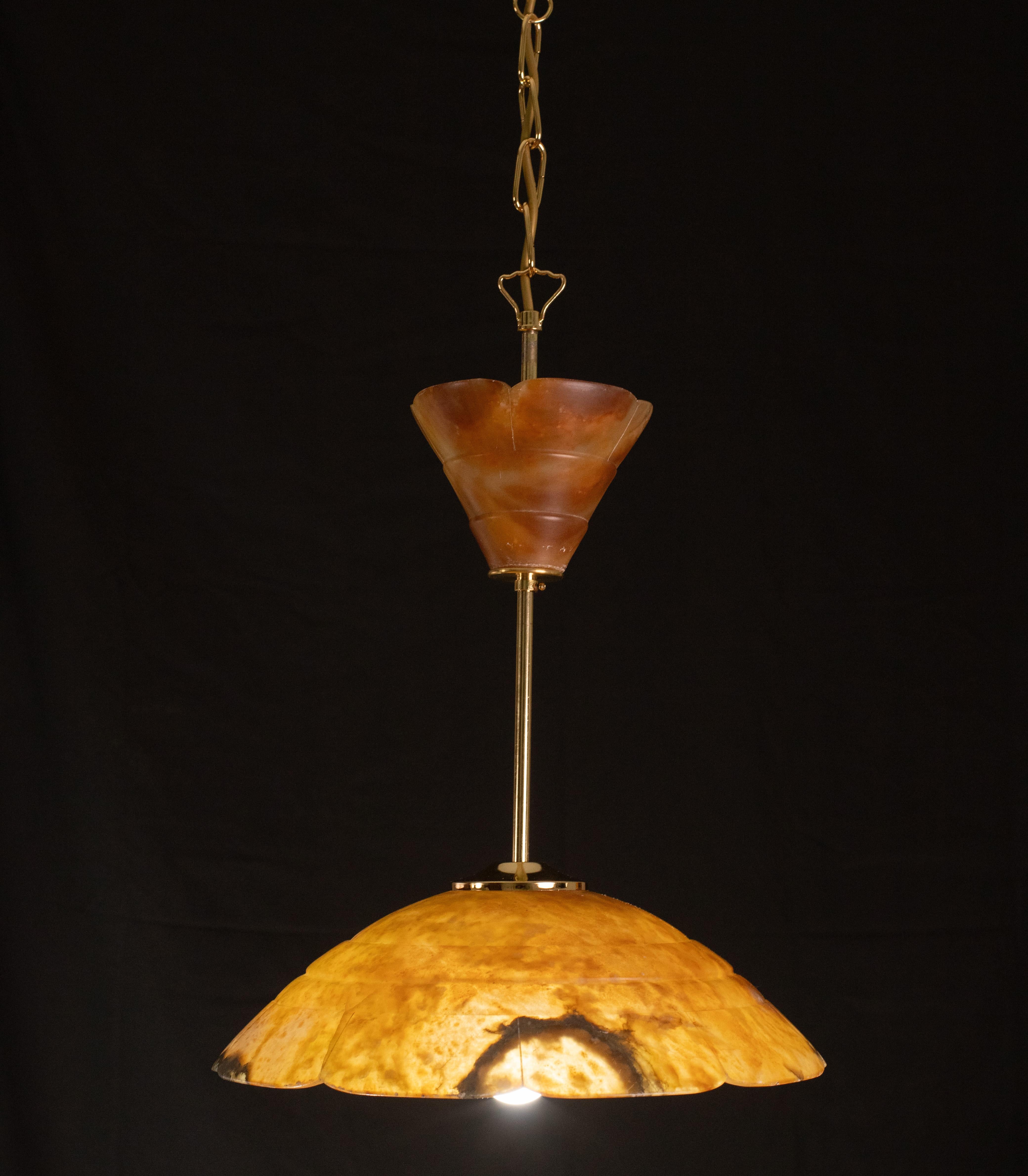 Antique alabaster hanging lamp in Art Deco style, circa 1940s. A unique piece of alabaster, beautifully worked. The light that shines through the alabaster is warm and suggestive and exudes a beautiful atmosphere both when switched on and off.