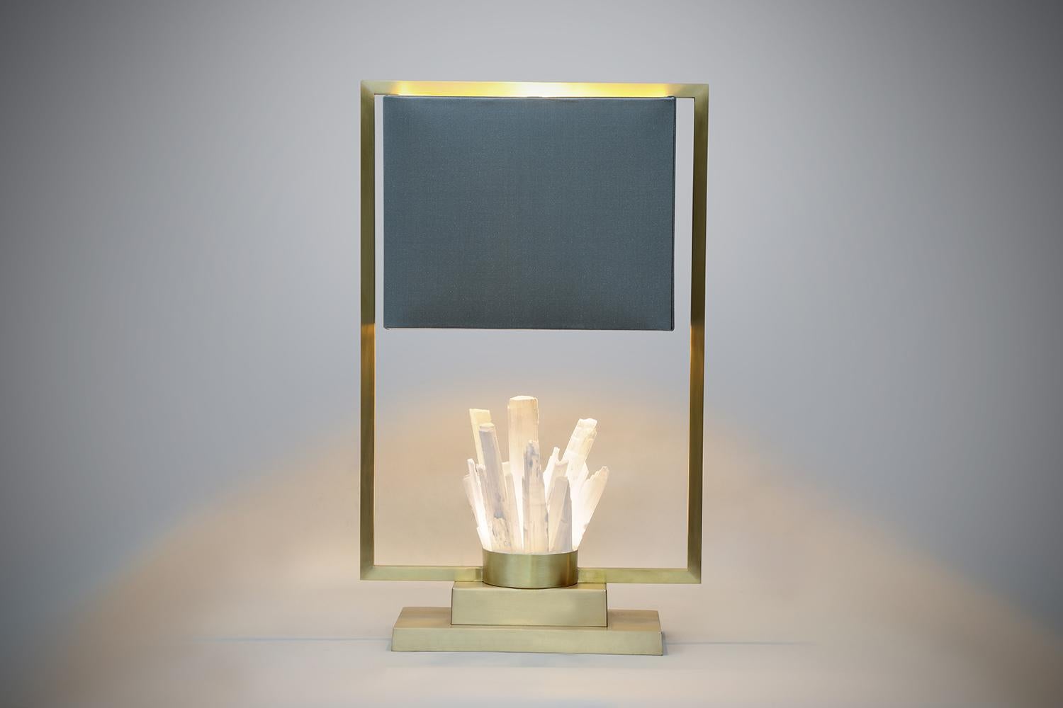 The rawest form of rock crystal rods are the central feature of this beautiful lamp. Uniquely positioned, the shade sits within an outer bronze frame, all delicately handcrafted with the softest of finishes.

Each light is limited in the number ever