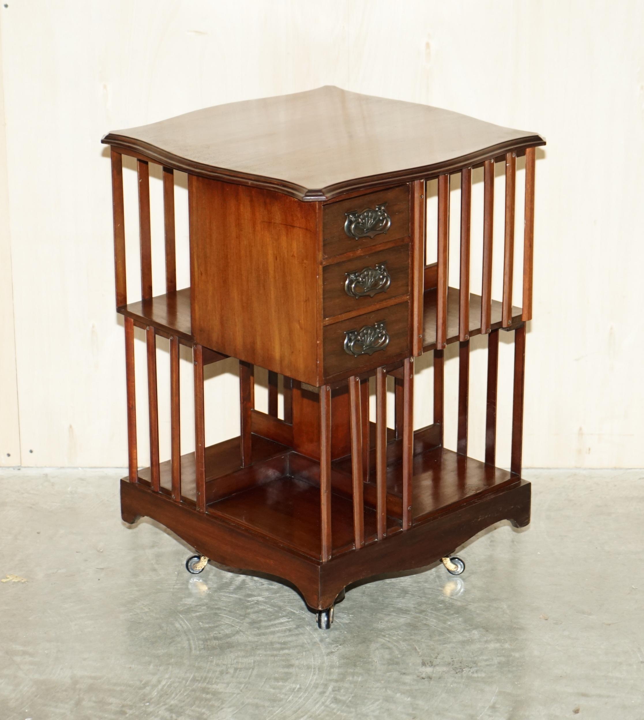 We are delighted to offer for sale this exhibition quality Liberty's London style English Mahogany, circa 1880 revolving bookcase table with serpentine top and very rare small drawer section 

A good looking and well made piece, this is the first