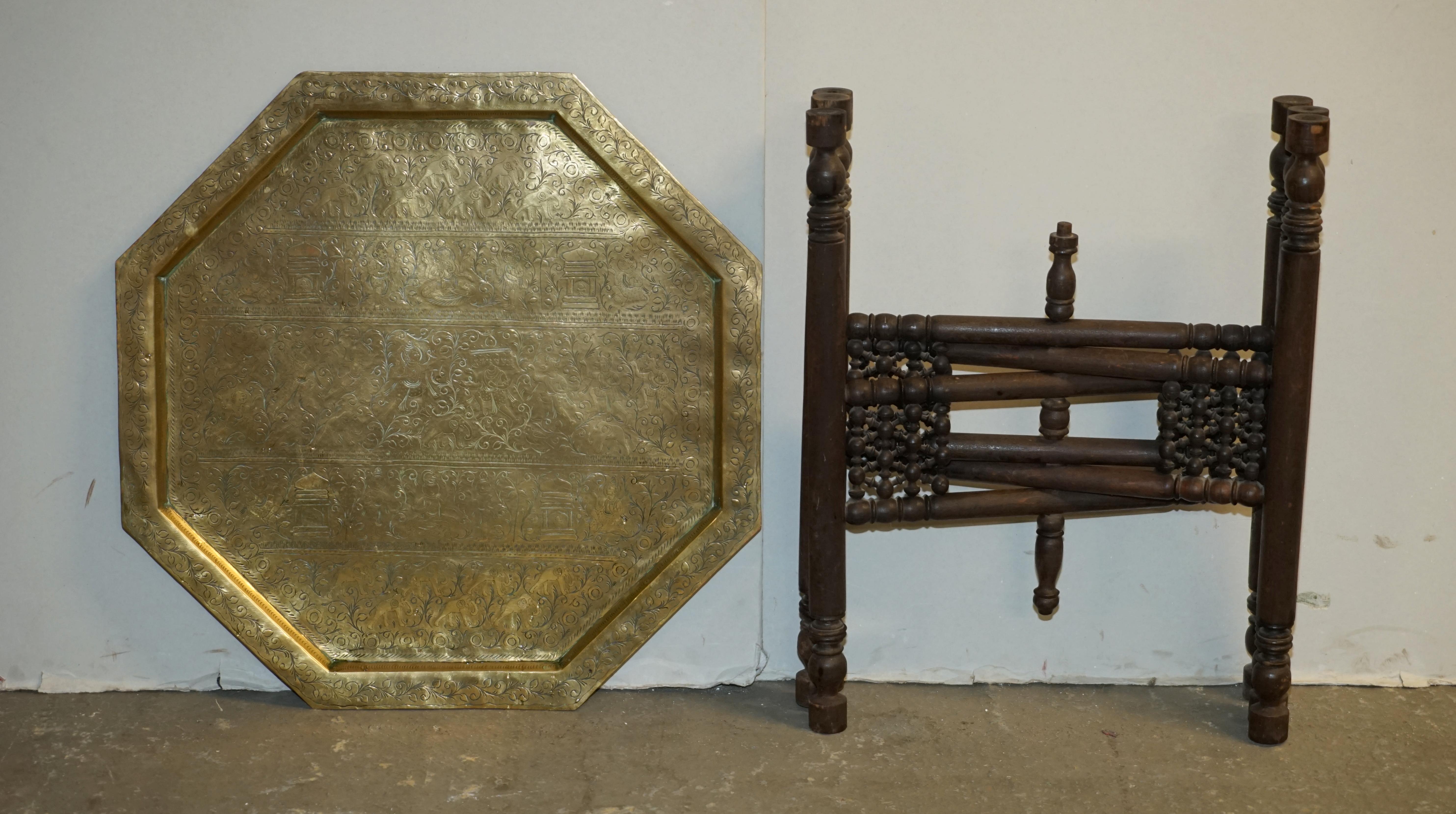 Here we have for sale this ornately hand carved Moroccan brass tray table retailed through Liberty's London in the 1880-1900's. They are perfect as serving tables as you simply remove the top and pass it around the room.

Overall, the table is in