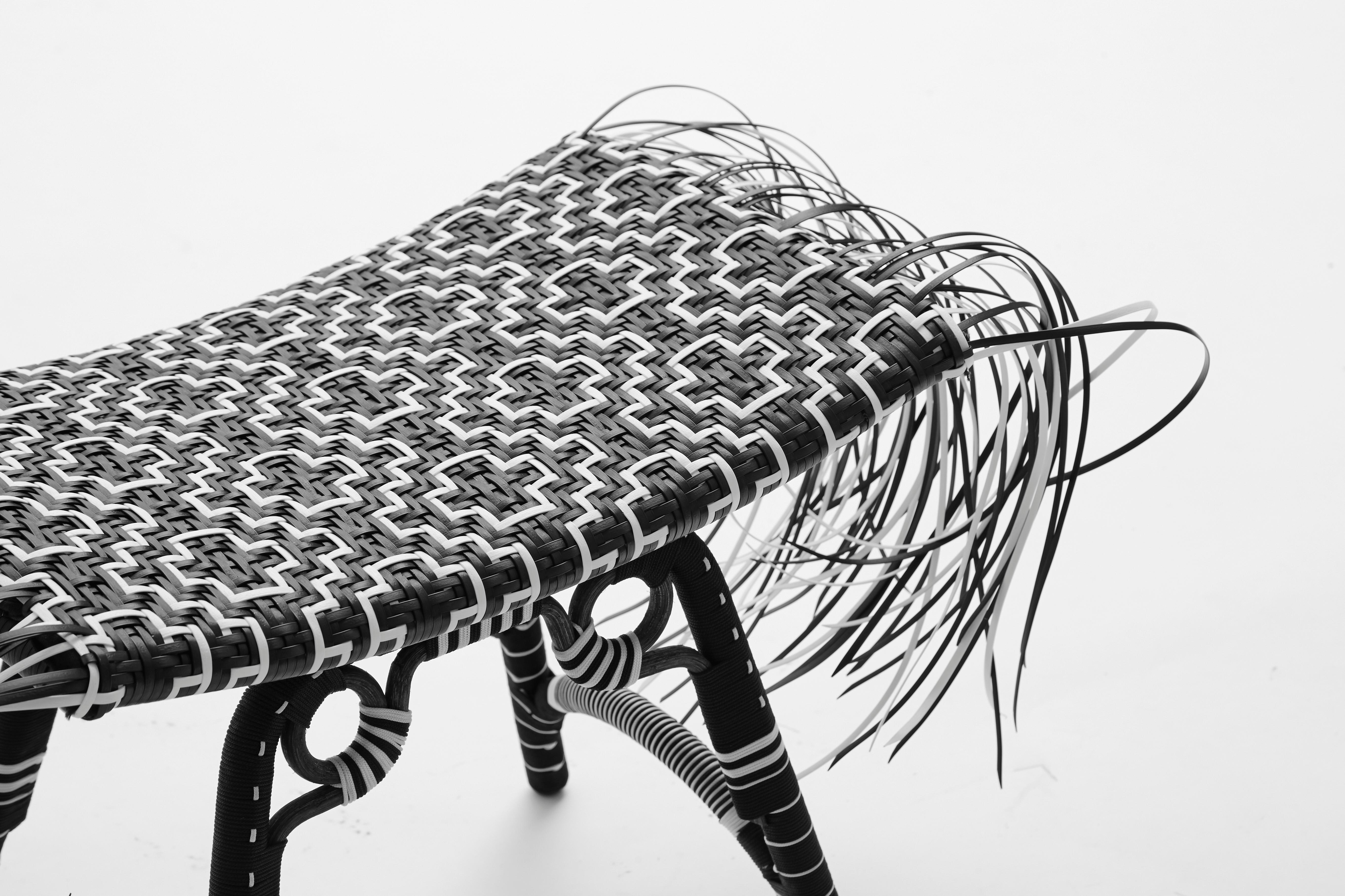 Libra stool, tribal stool 

Inspired by the African Ashanti stool, the Libra has been re-contextualized with modern materials such as steel and recycled plastic strips. Kitt.Ta.Khon melds African references with Southeast Asian wicker techniques