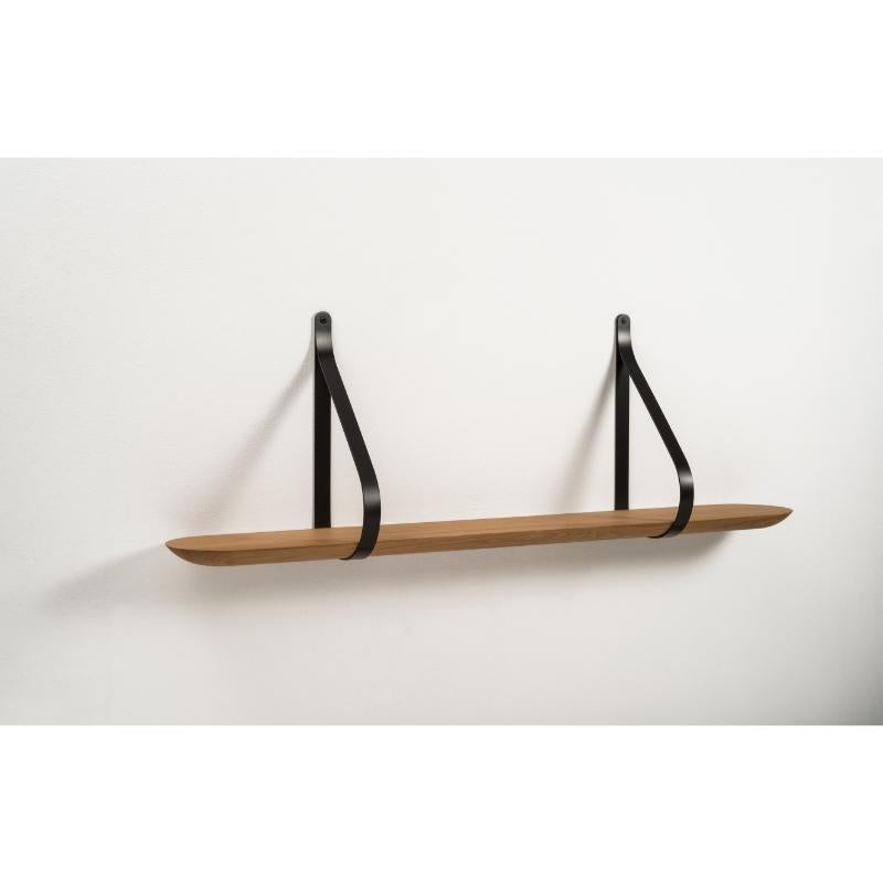 Libra shelf 120 by Colé Italia with Martinelli/Venezia
Dimensions: H.42 D.20 W.124 cm
Materials: Shaped solid oak wall shelf; black lacquered iron stirrups

Also available: Libra Shelf 60

A minimalist shape with a strong aesthetic, Libra