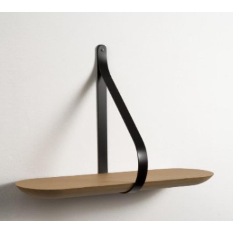 Libra Shelf 60 by Colé Italia with Martinelli/Venezia
Dimensions: H.42 D.20 W.55 cm
Materials: Shaped solid oak wall shelf; black lacquered iron stirrups

Also Available: Libra Shelf 120,

A minimalist shape with a strong aesthetic, Libra plays with