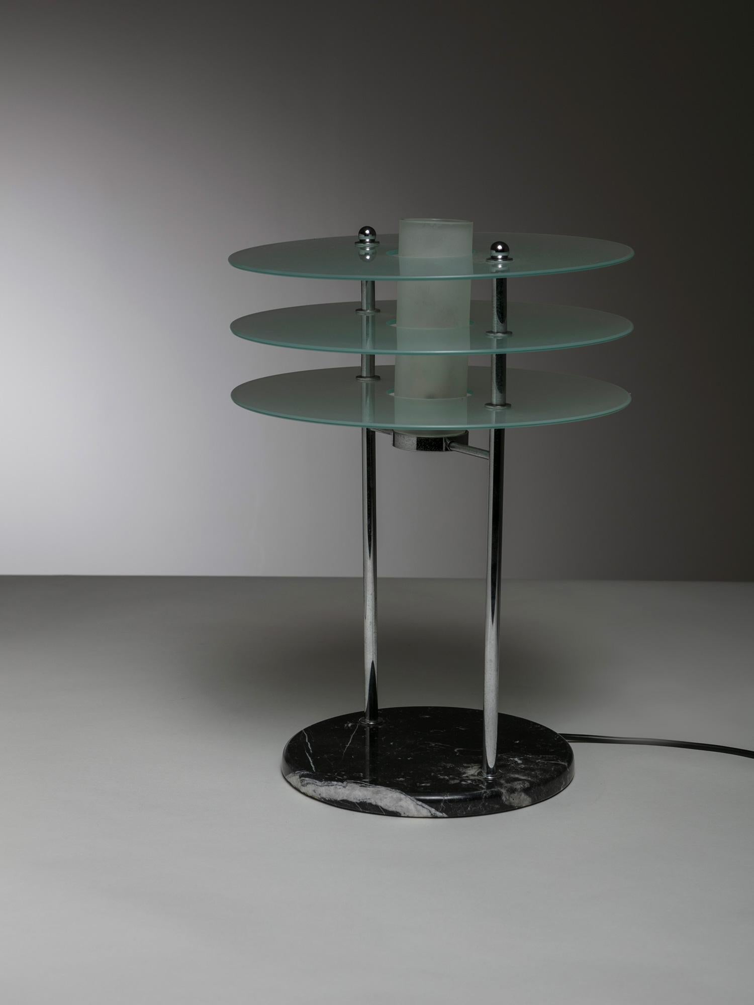 Libra table lamp by Roberto Volonterio and Cesare Benedetti for Quattrifolio.
Ethereal lamp composed by three sandblasted glass discs, black marble base and chrome frame.