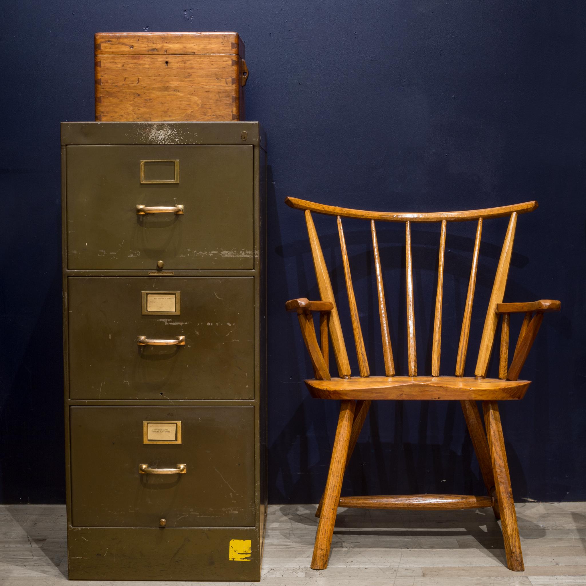 About:

An antique army green steel file cabinet with three drawers, rich brown linoleum top and original labels. Each drawer has a divider that slides smoothly. Each handle has a unique release lever that unlocks the drawers. The handles, name