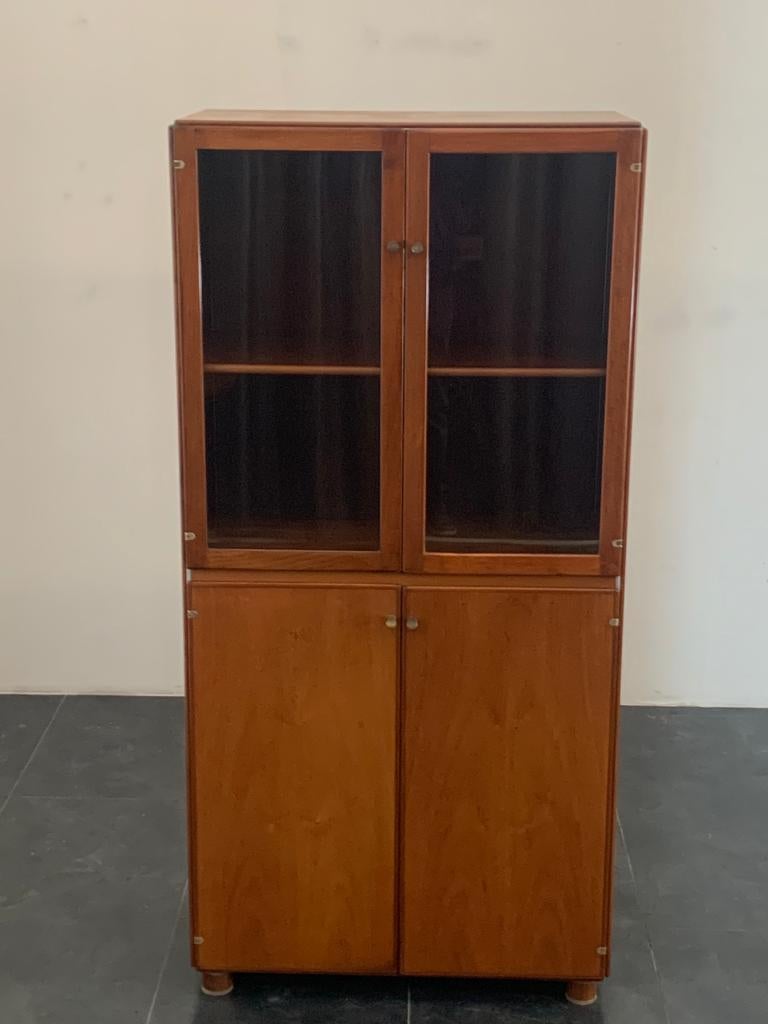 Torcello bookcase, an innovative project in the early 1960s that allowed wooden panels to be joined by a metal profile. Torcello is an example of good cabinet-making and innovation. The wood is walnut. The doors are completely airtight, dustproof