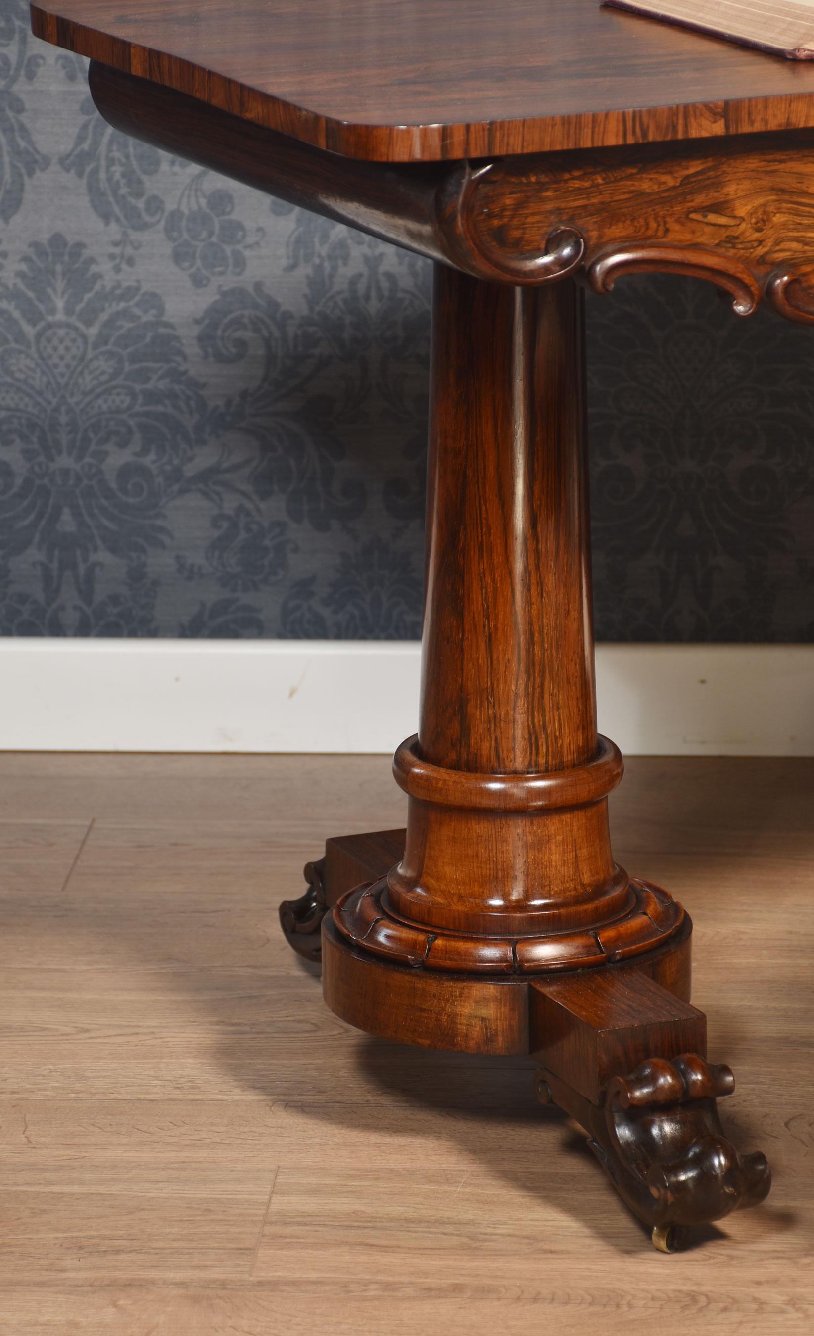 Library table, the rectangular top with rounded corners, above a frieze drawer, raised on tapering columns and trestle ends, terminating in scrolling toes with recessed castors.
Dimensions
Height 29 Inches
Width 48.5 Inches
Depth 26 Inches