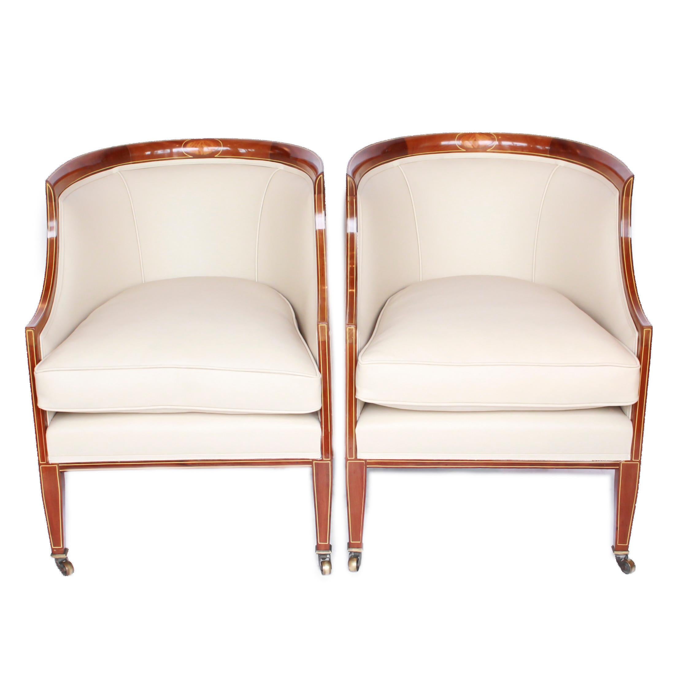 A pair of mahogany, library tub chairs. Re-upholstered in cream leather. Satin wood and boxwood inlay on original brass casters.

Dimensions: H 77cm, W 55cm, seat H 37cm, seat D 55cm

Origin: English

Date: circa 1920

Item no: 2011192.