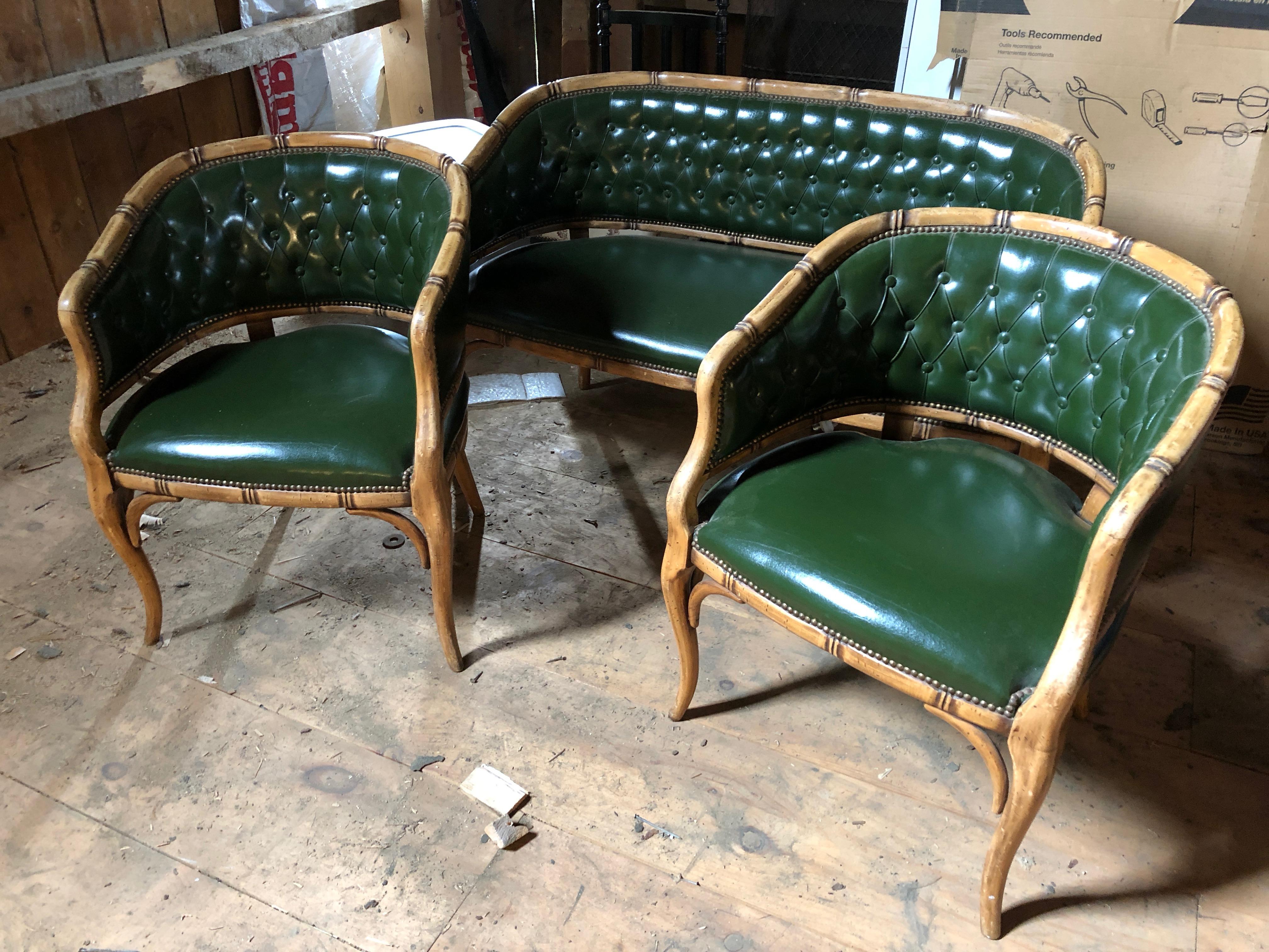 Highly decorative antique French three-piece salon suite, comprised of a sofa and a pair of armchairs/fauteuils, mid-20th century. Popular faux bamboo style and high quality original faux green leather in excellent condition in traditional forest
