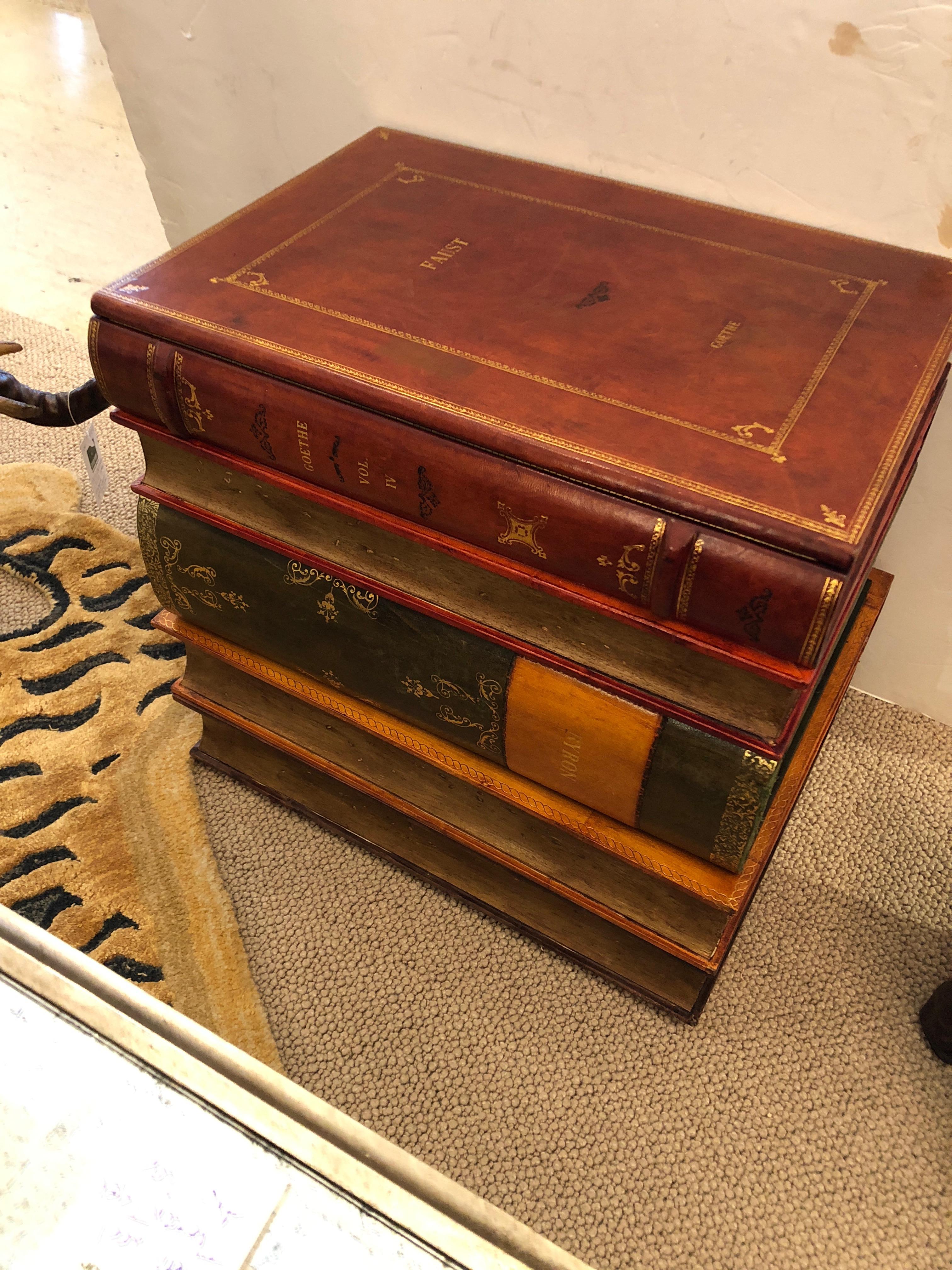 Stunning gilt and leather bound stacked book form table with lift up top revealing a storage compartment and single drawer. Green and white Italian papered interior.
 