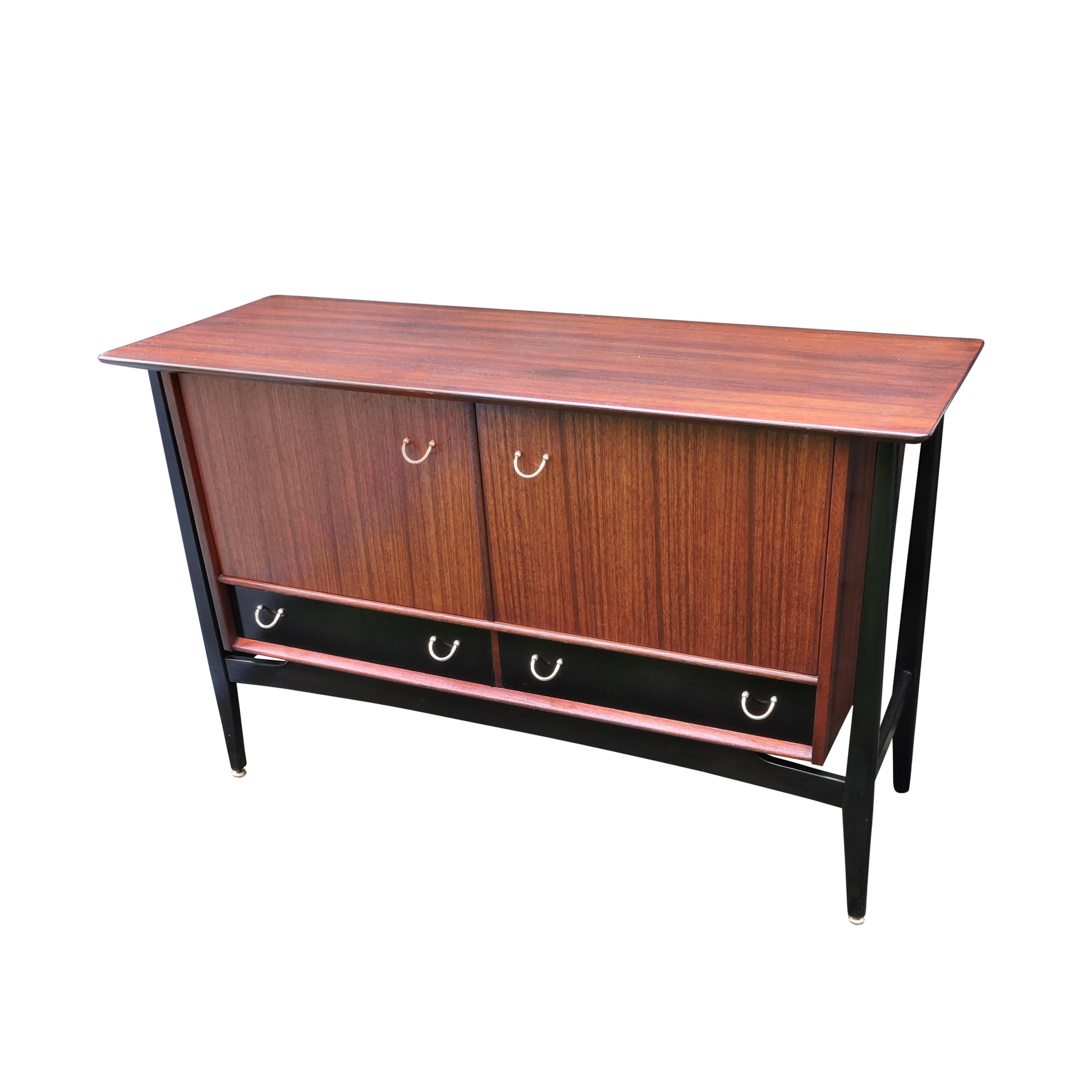 - Sideboard produced by G-Plan in the 1950s.
- Tola wood
- Brass handles
- Ebonised legs.