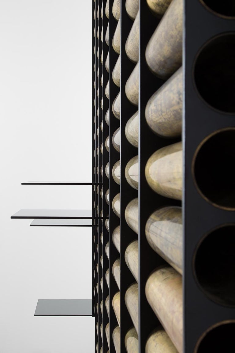 Modular shelving system. Each module is in matte black painted metal and oxidised brass tubes. Shelves are in smokey tempered glass. 
Published price is for 1 module, including 4 glass shelves. More shelves can be purchased separately.
Progetto Non