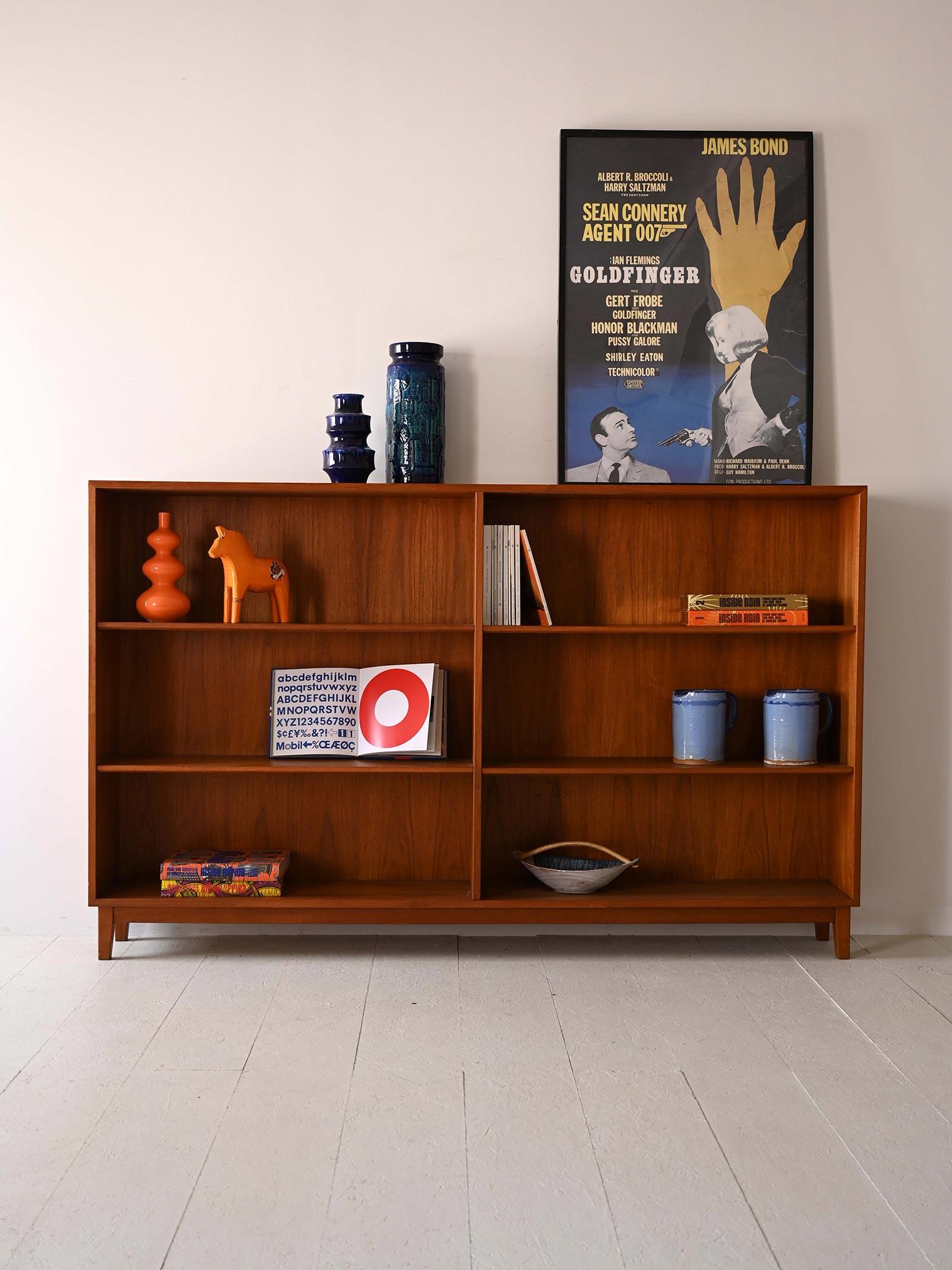 1960s Scandinavian bookcase.

This piece of furniture is an example of clean, functional design that characterizes the era of modernism. Its teak wood frame, features shelves of various sizes that allow versatile display of objects and books, while