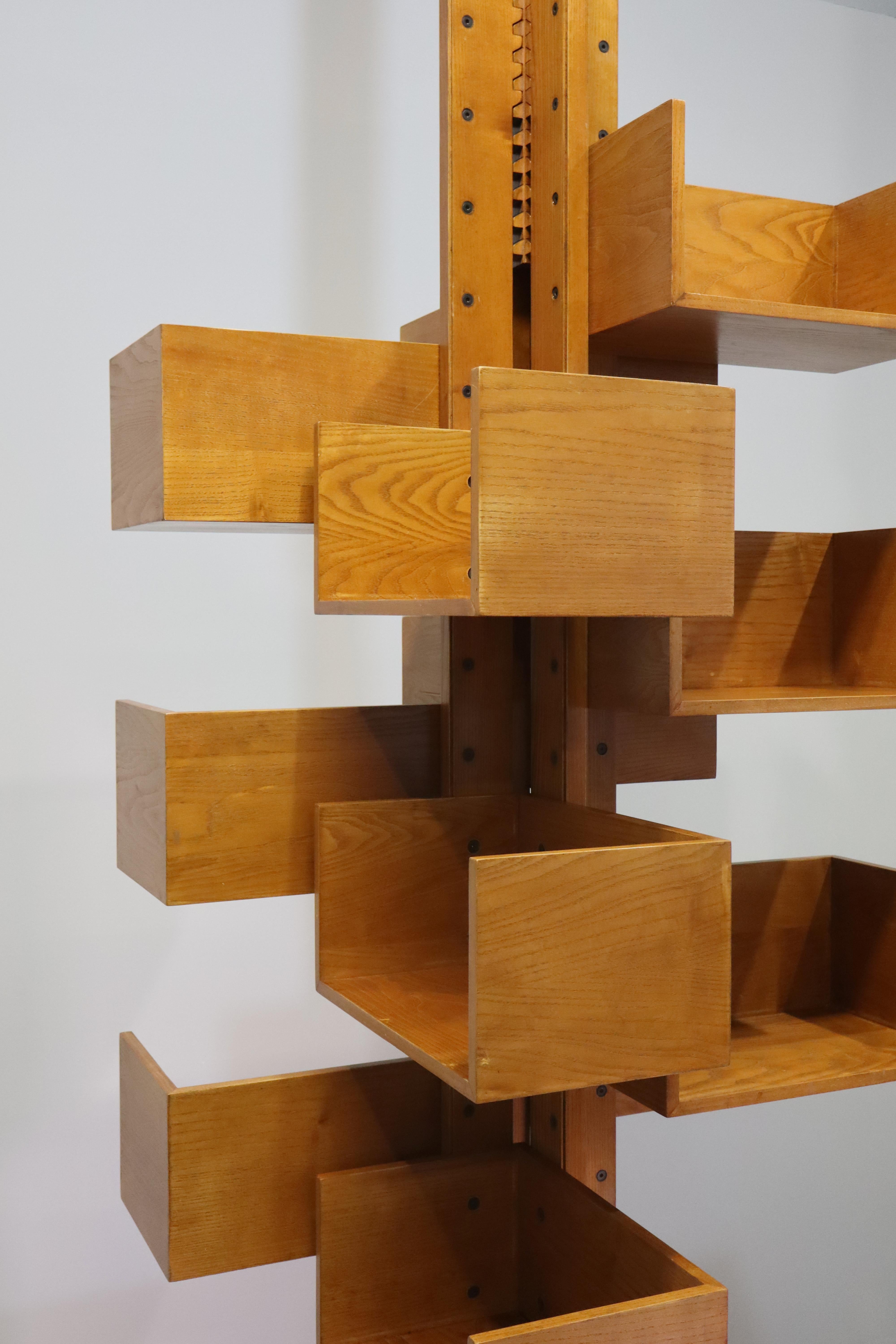 The 12-shelf Albero bookcase designed by  Gianfranco Frattini for Poltrona Frau   It has four vertical posts and two rack posts at either end, all made of solid ash. The shelves, with ash veneer, can be placed in the holes along the uprights as