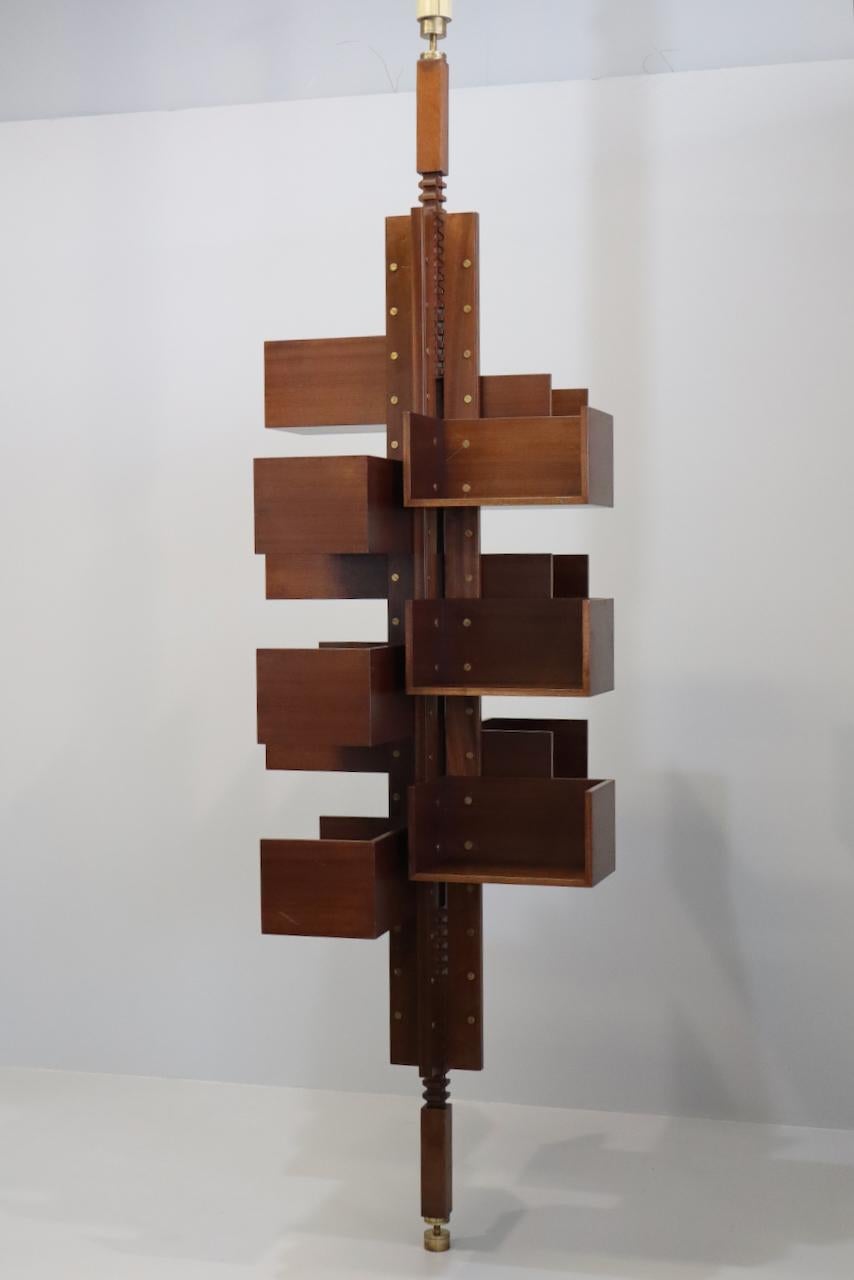The 12-shelf Albero bookcase designed by  Gianfranco Frattini for Poltrona Frau   It has four vertical posts and two rack posts at either end, all made of solid ash. Shelves, , can be placed in the holes along the uprights as desired with a minimum