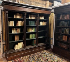 Solid walnut bookcase, carved with columns, Italy