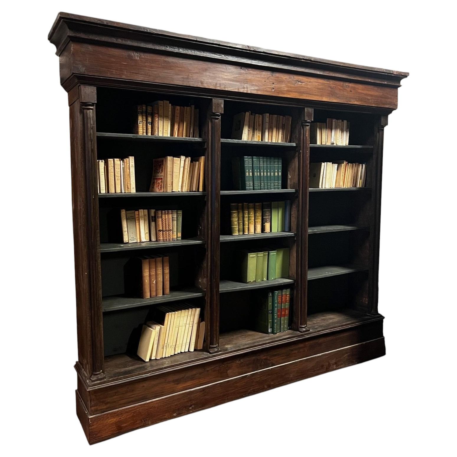 Solid walnut bookcase, carved with columns, Italy