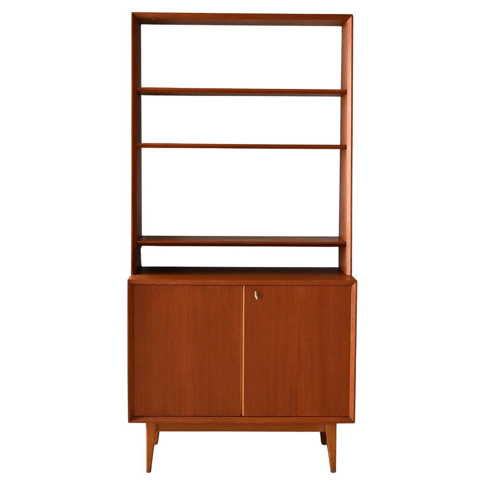 Scandinavian 1960s teak bookcase with storage compartment For Sale