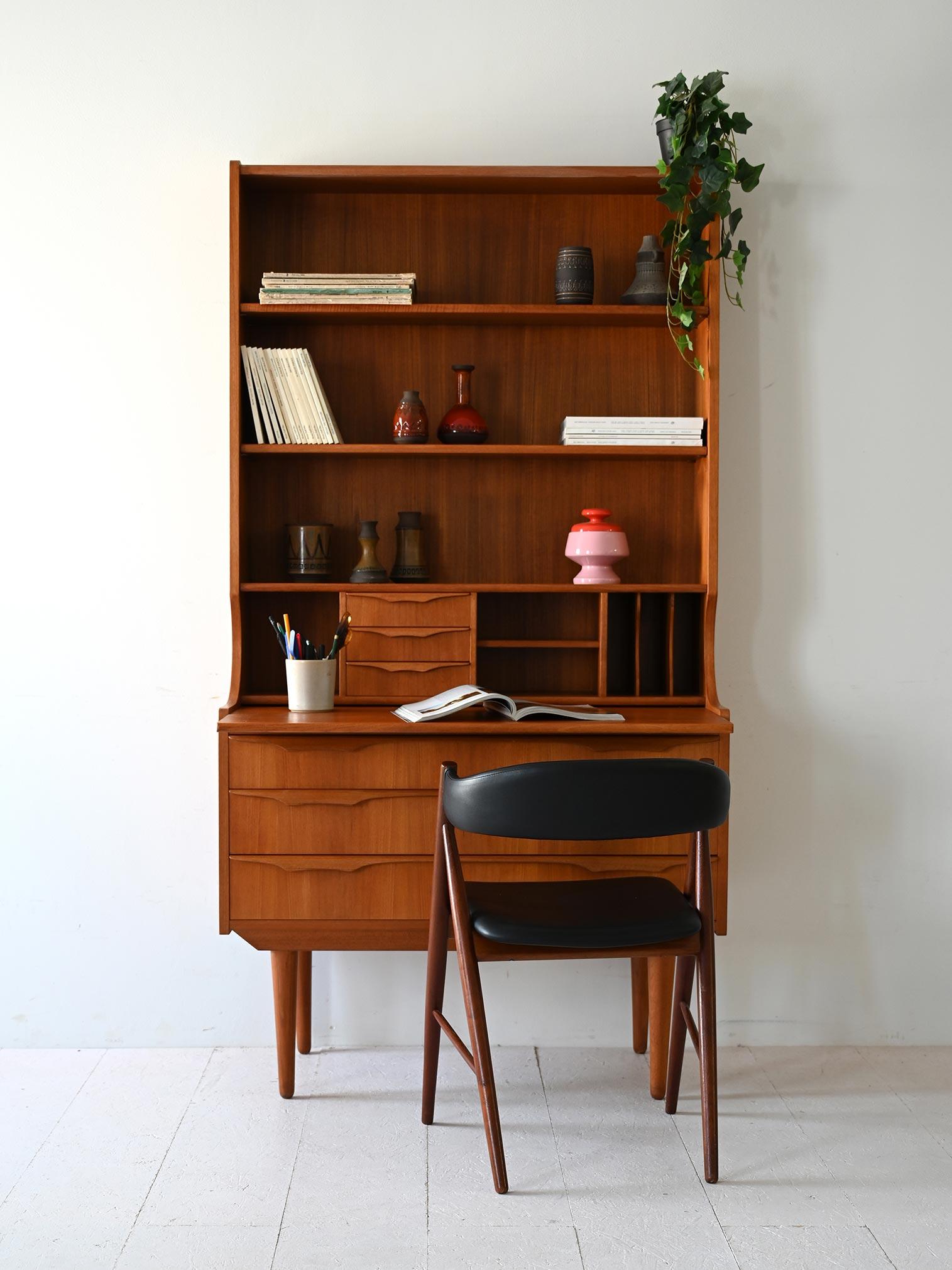 1950s teak cabinet with three drawers, interlocking flap, three shelves and compartments with drawers and paper holders.

Rare 1950s Scandinavian teak cabinet combining bookcase and roll-away desk. The top section features three shelves, while the
